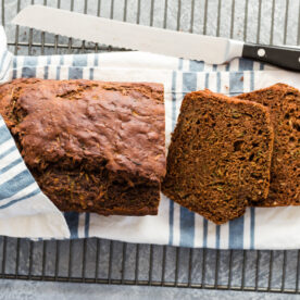 Chocolate zucchini bread sliced on wire rack.