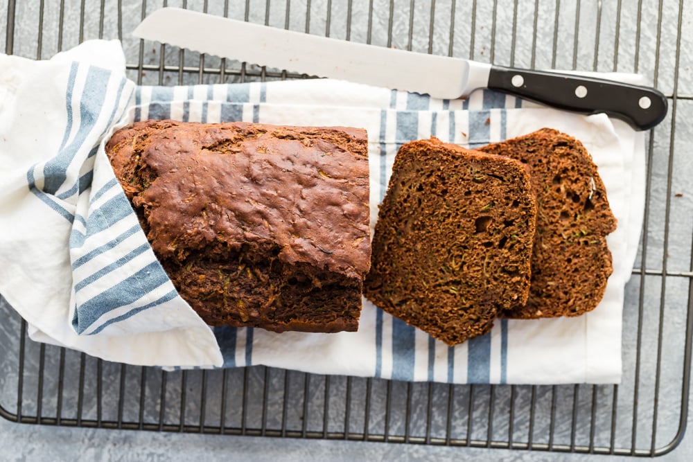 Chocolate zucchini bread sliced on wire rack.