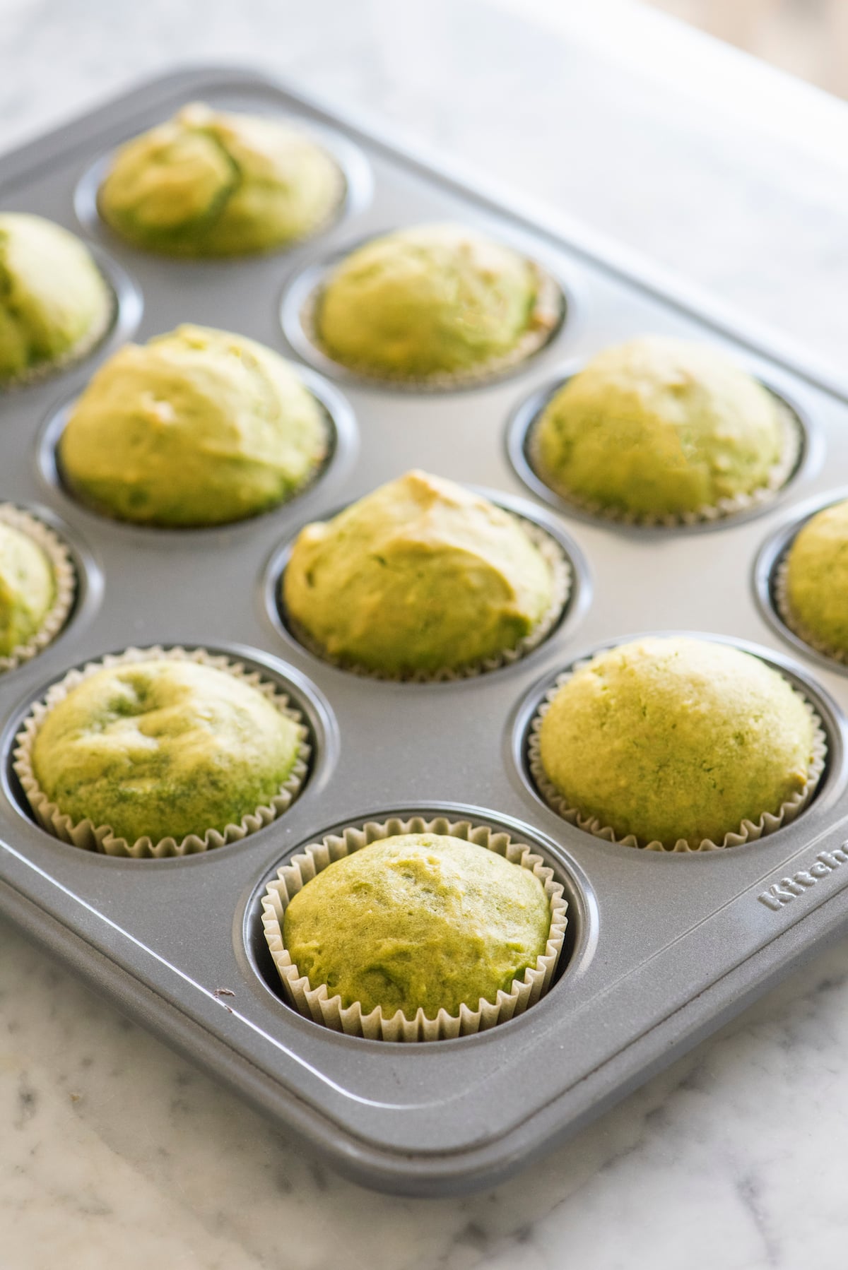 Spinach cake muffins in muffin tin.