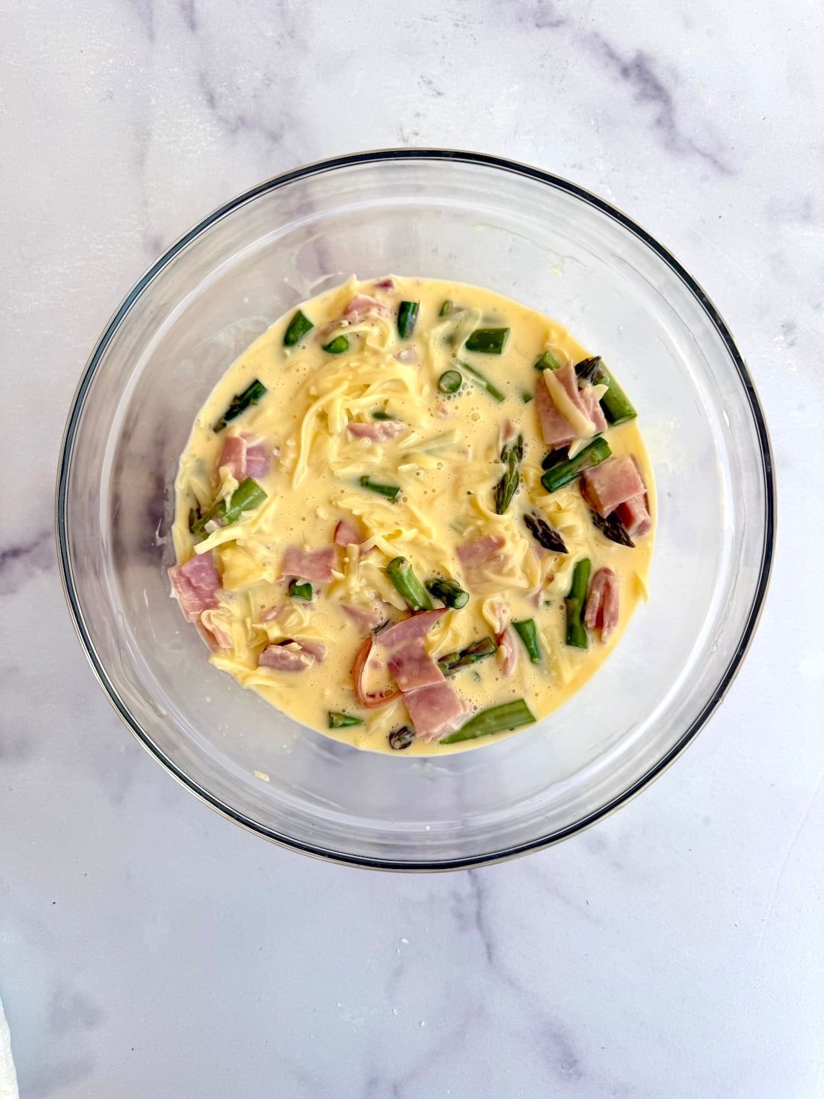 Ham and asparagus quiche filling in a bowl.