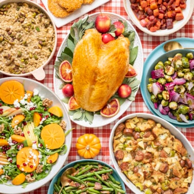 Thanksgiving dinner on a red and white checkered tablecloth.
