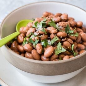 Pressure cooker pinto beans in a bowl.
