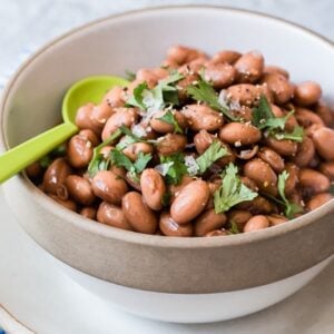 Pressure cooker pinto beans in a bowl.