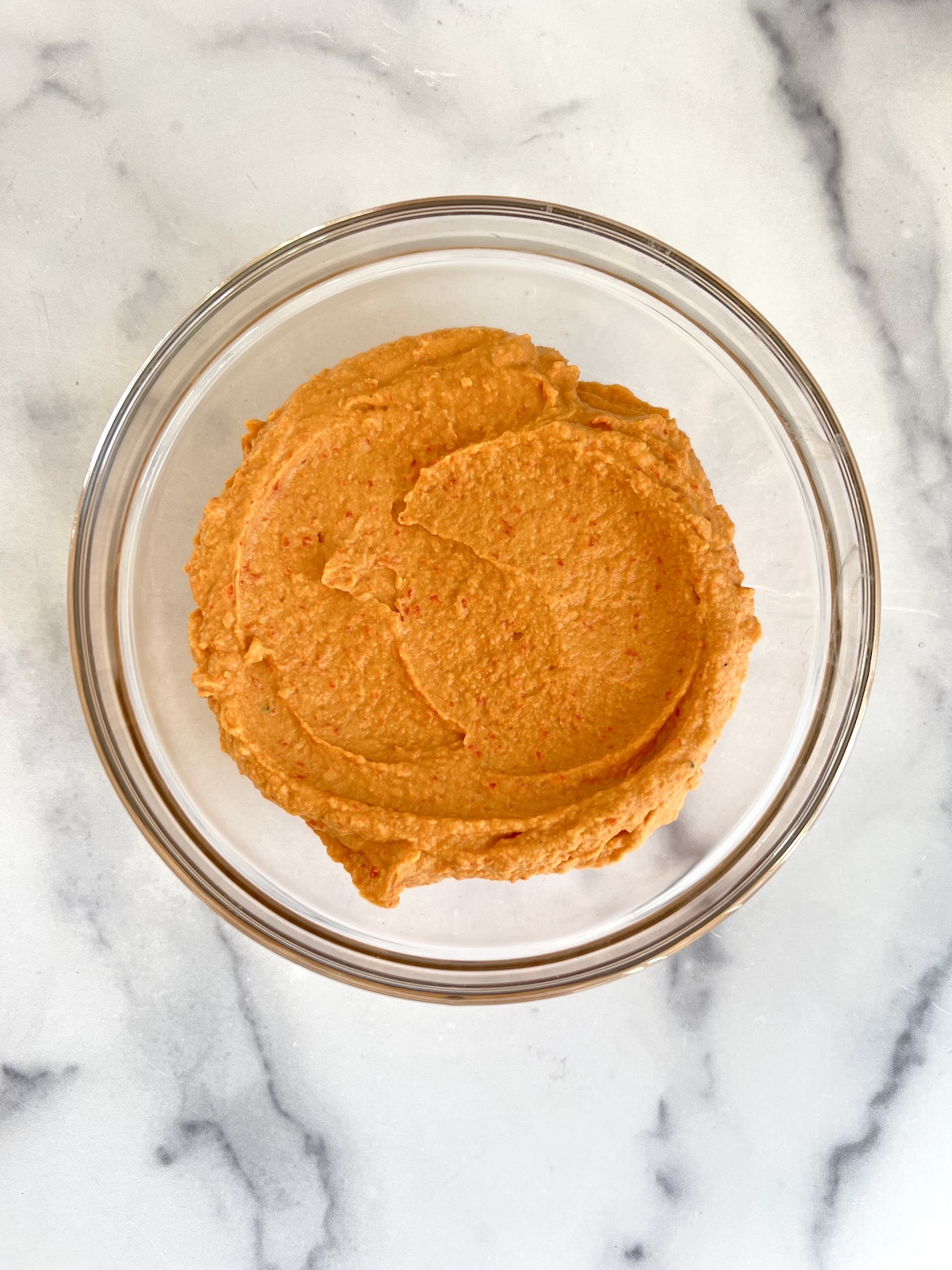 Red bell pepper hummus is a mixing bowl.