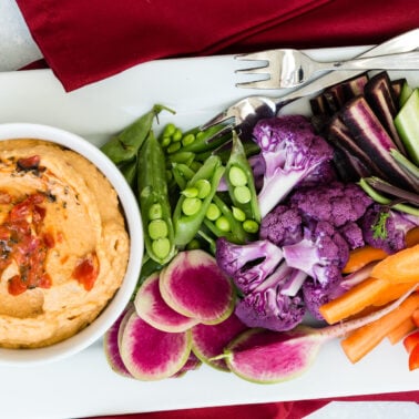 Red Bell Pepper Hummus served with fresh vegetables for dipping.