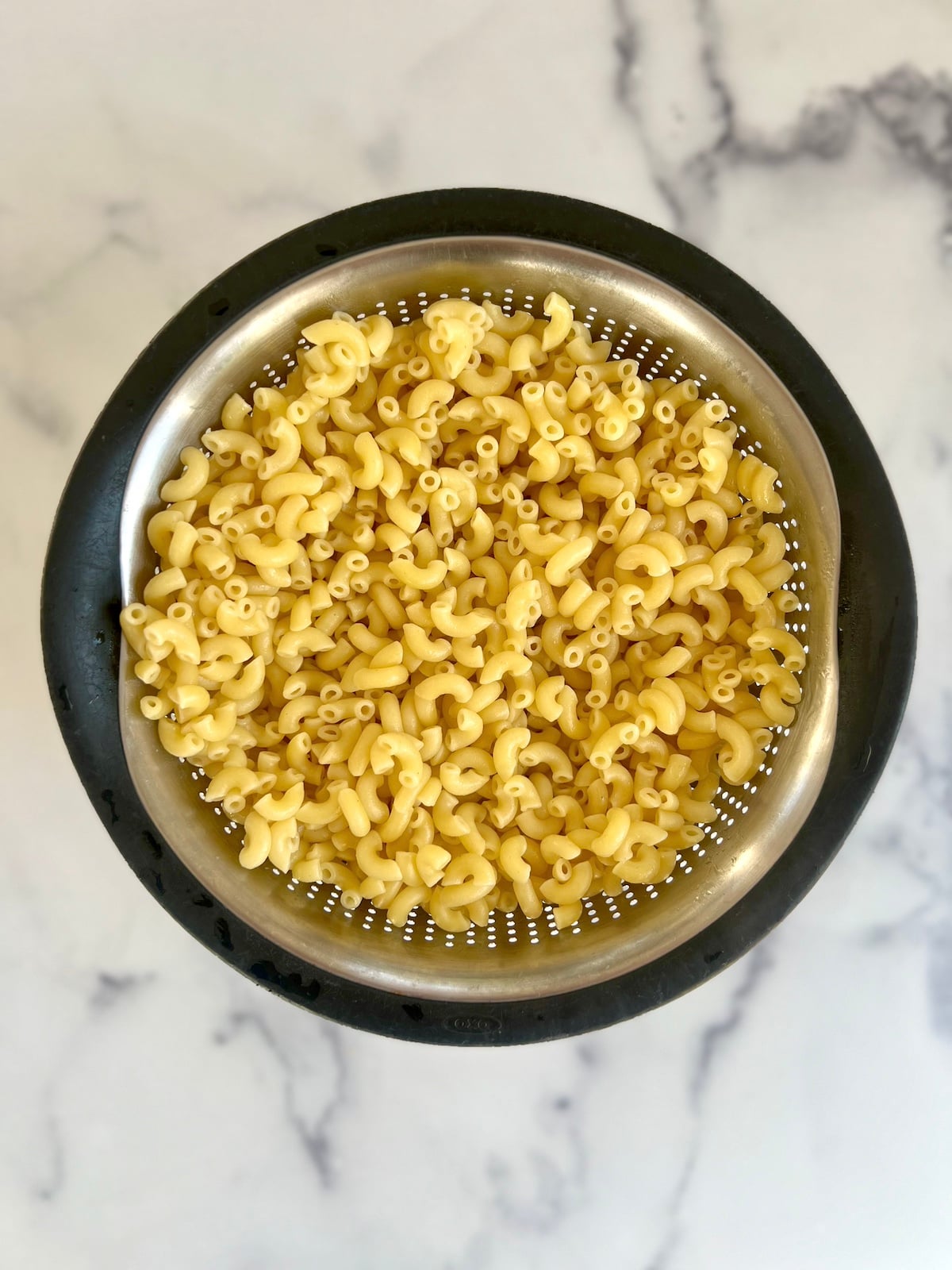 Drained pasta in a colander.