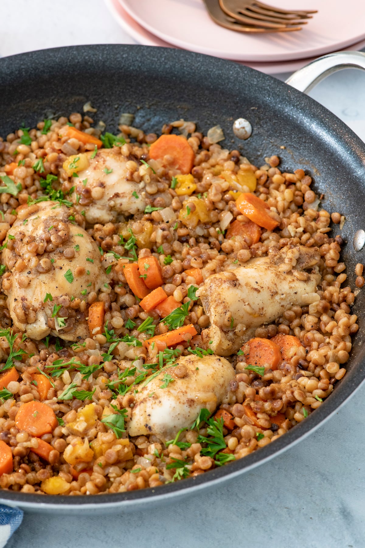 One Pot Spiced Chicken with toasted couscous in saute pan.
