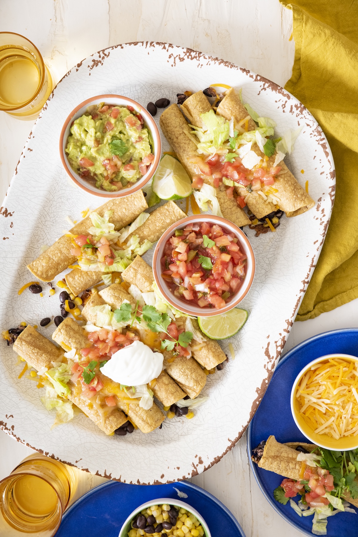 Vegetarian baked taquitos on a serving platter.