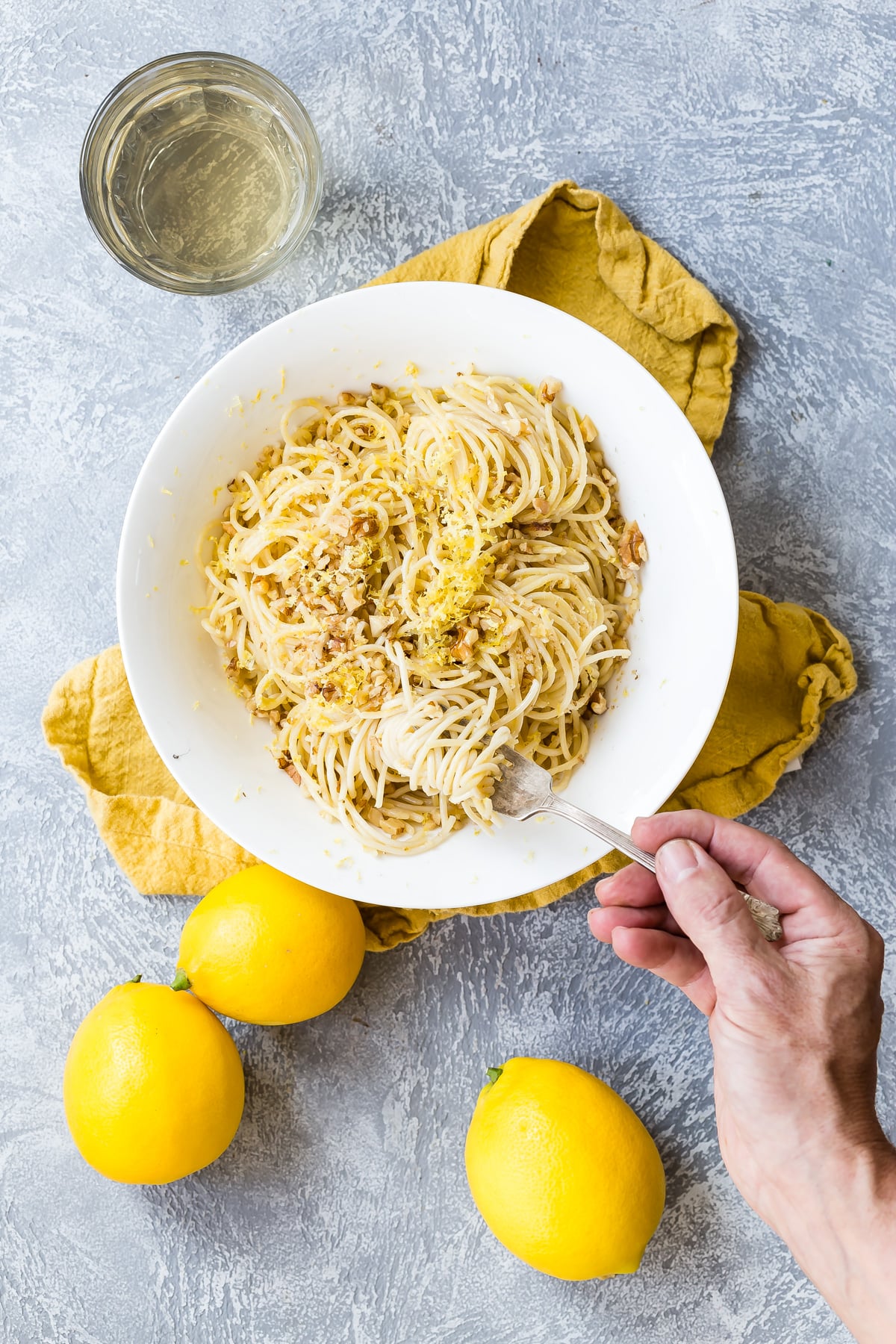 Lemon spaghetti with toasted walnuts in a bowl.