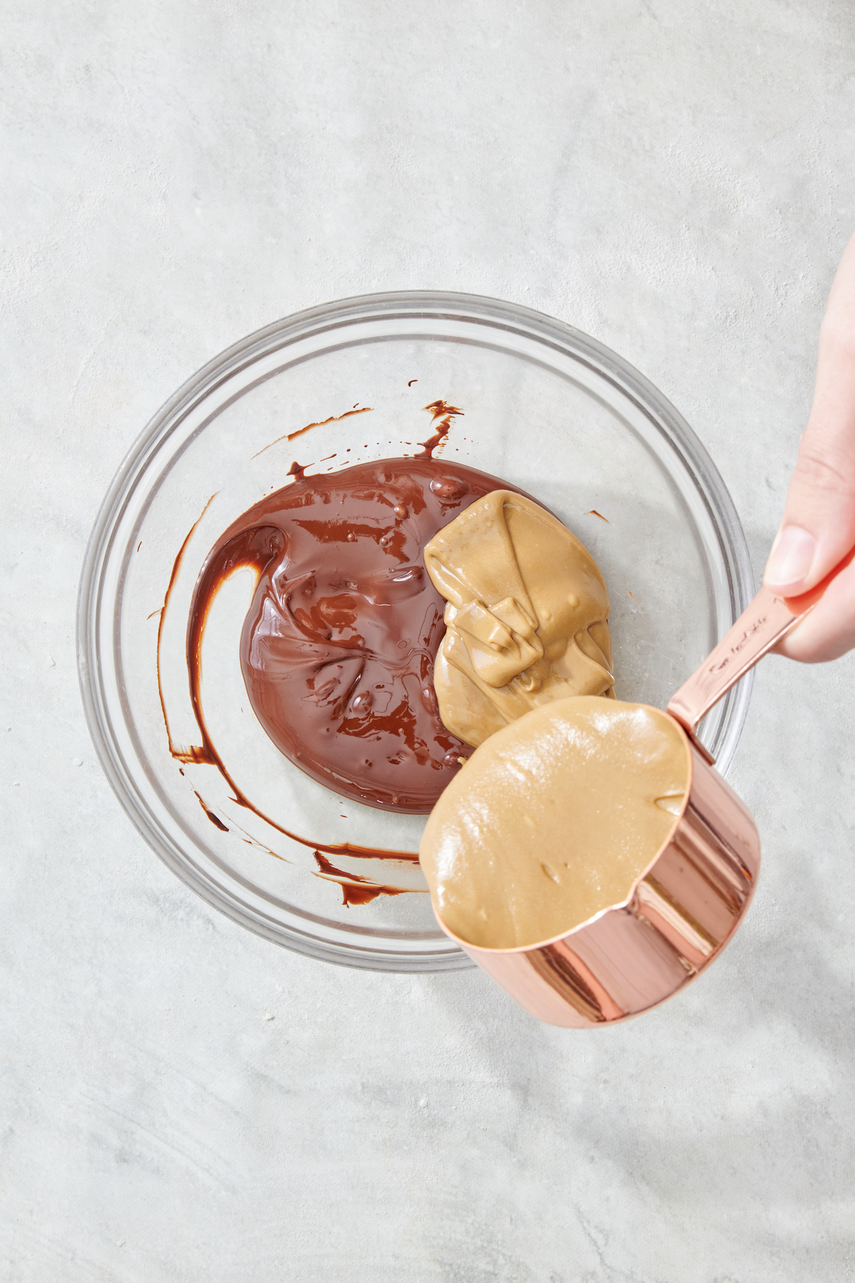Pouring sunbutter into melted chocolate.