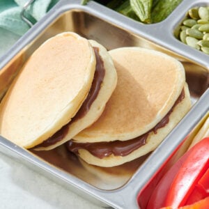 Chocolate sunbutter pancake sandwiches in a lunch box.