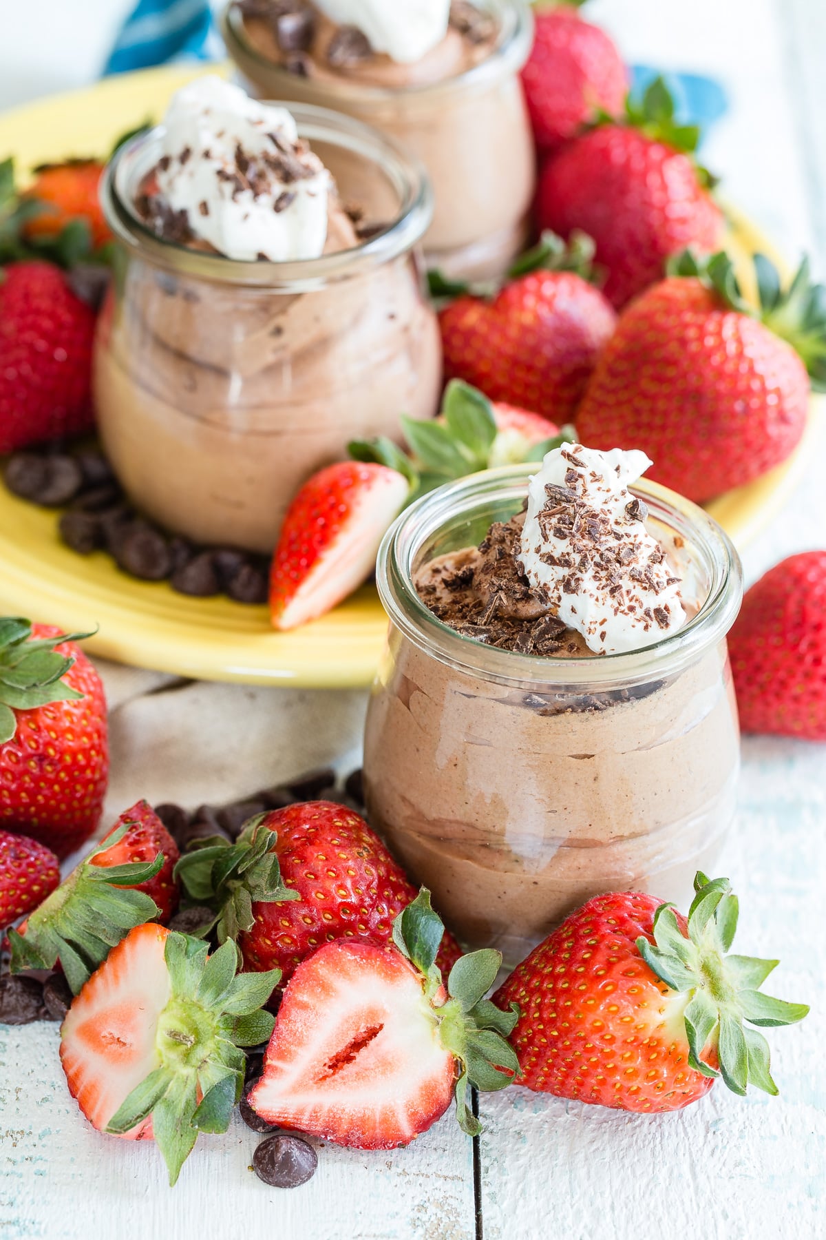 Eggless Chocolate Mousse in individual servings topped with whipped cream and sliced strawberries.