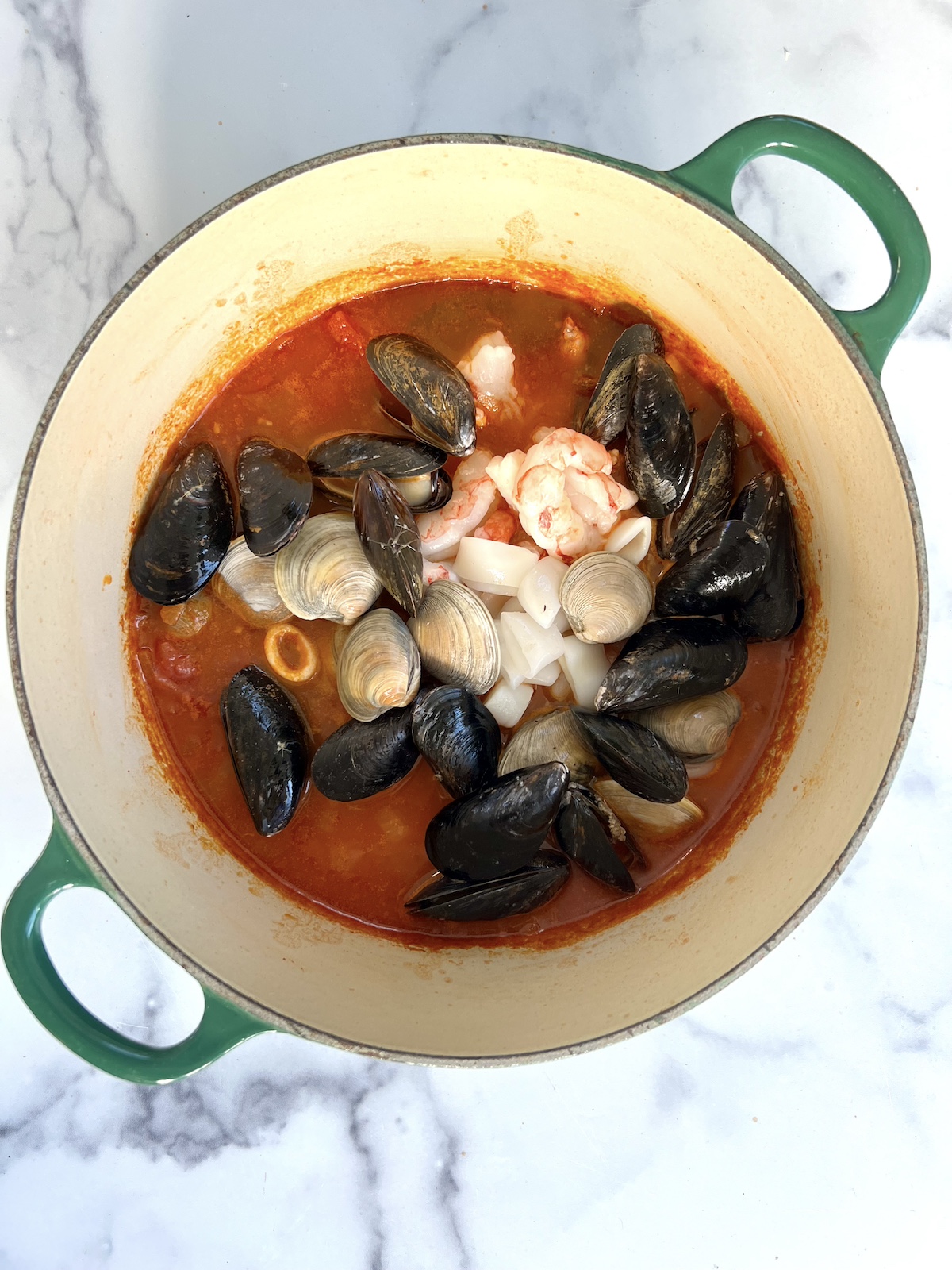 Seafood stew in stock pot.