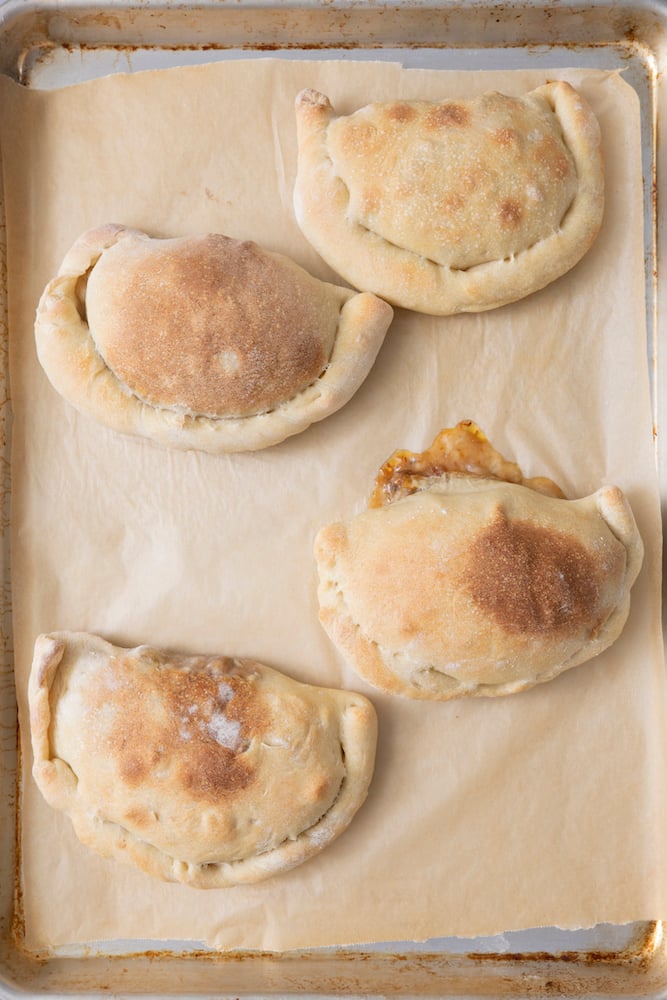 Cooked Vegetarian Calzones on baking sheet.