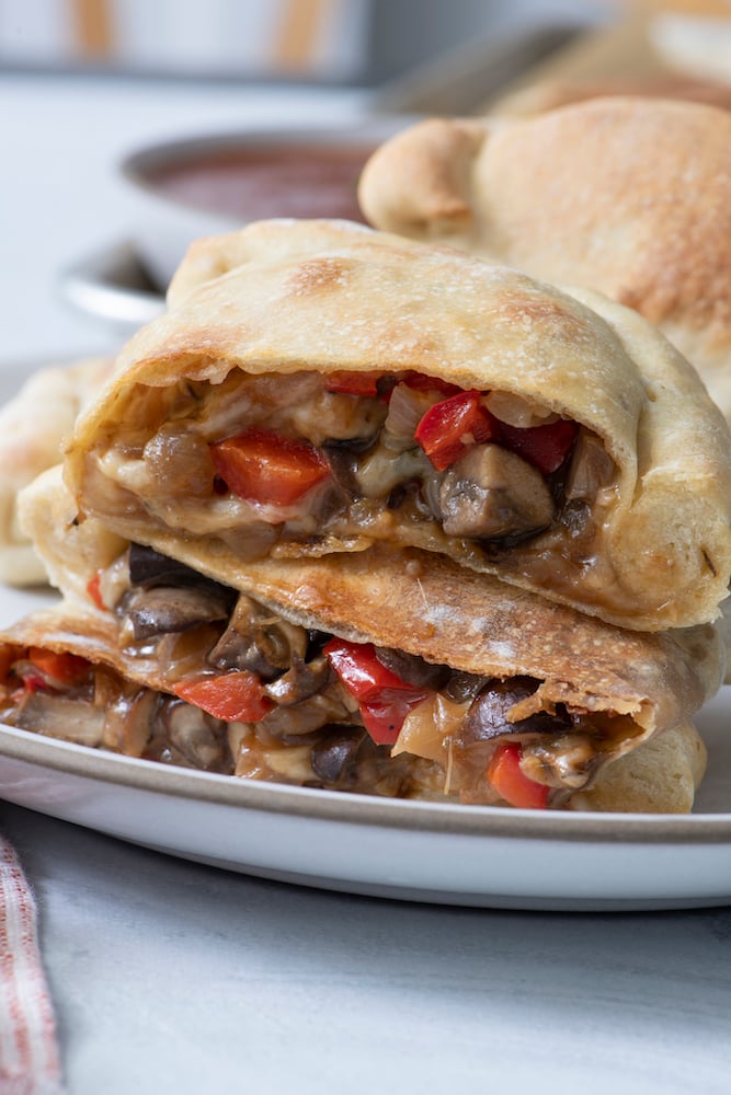 Vegetarian Calzones sliced in half and stacked on top of each other. 