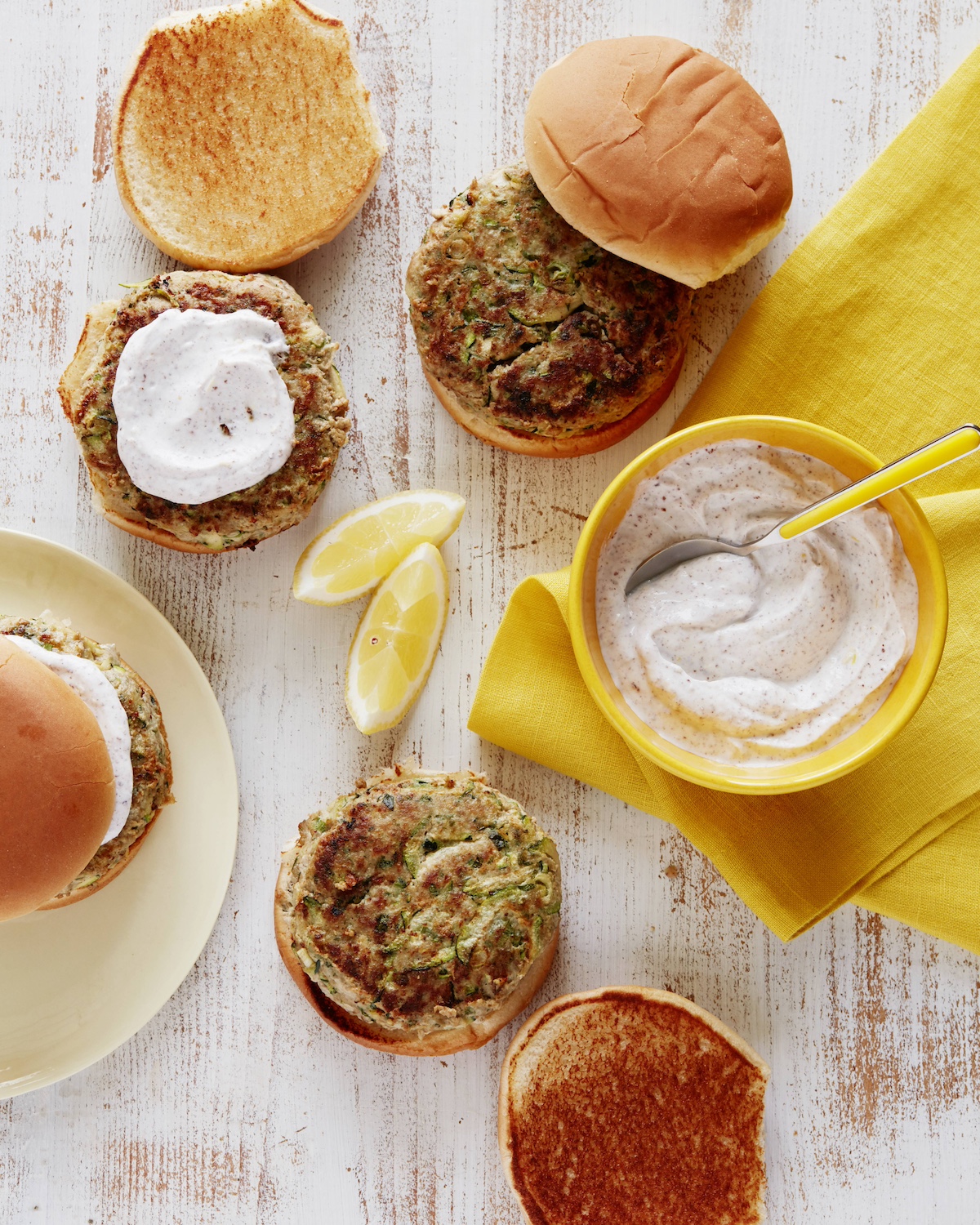 Turkey zucchini burgers served with yogurt sauce.