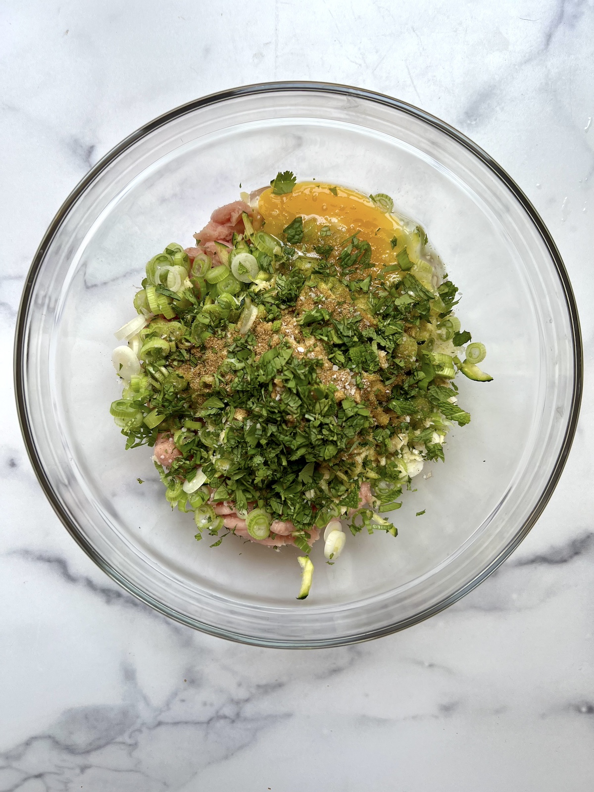 turkey zucchini burger ingredients in large mixing bowl.