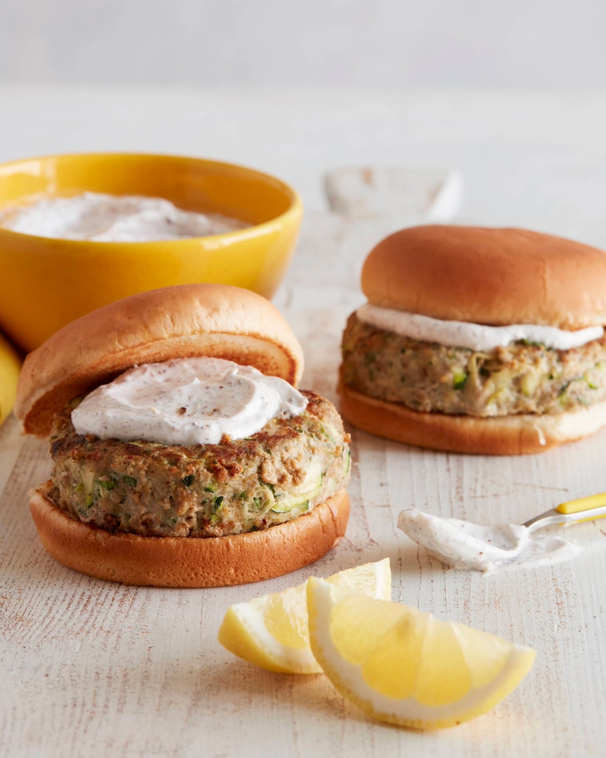 turkey zucchini burgers topped with yogurt sumac sauce.