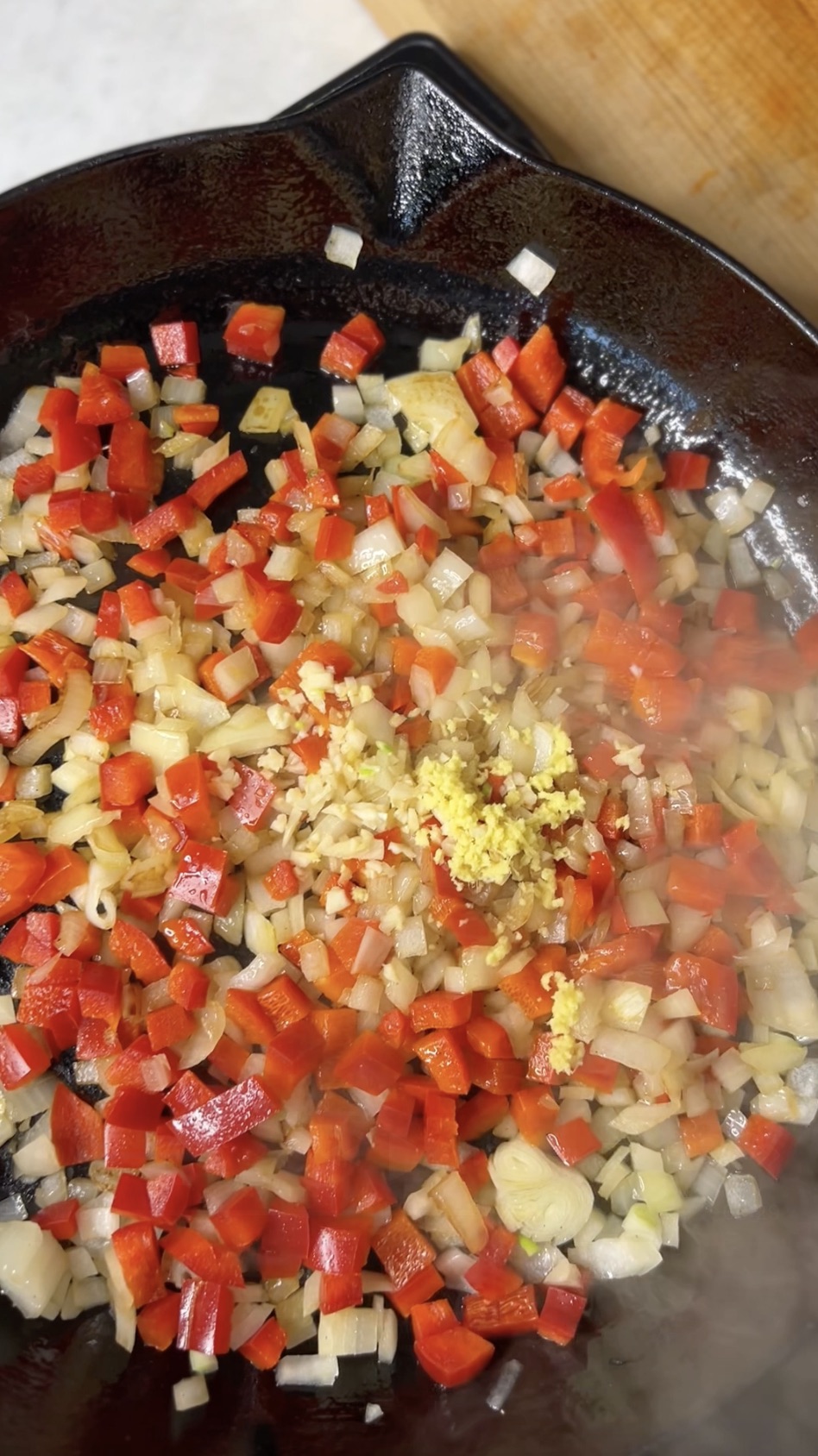 Garlic and ginger added to sauteeing onions and bell peppers.