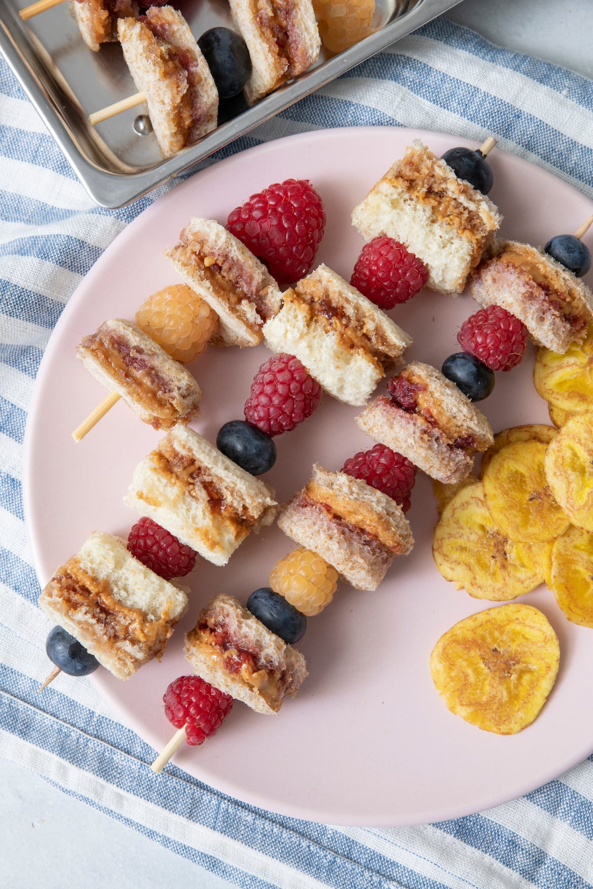 plate with peanut butter and jelly skewers