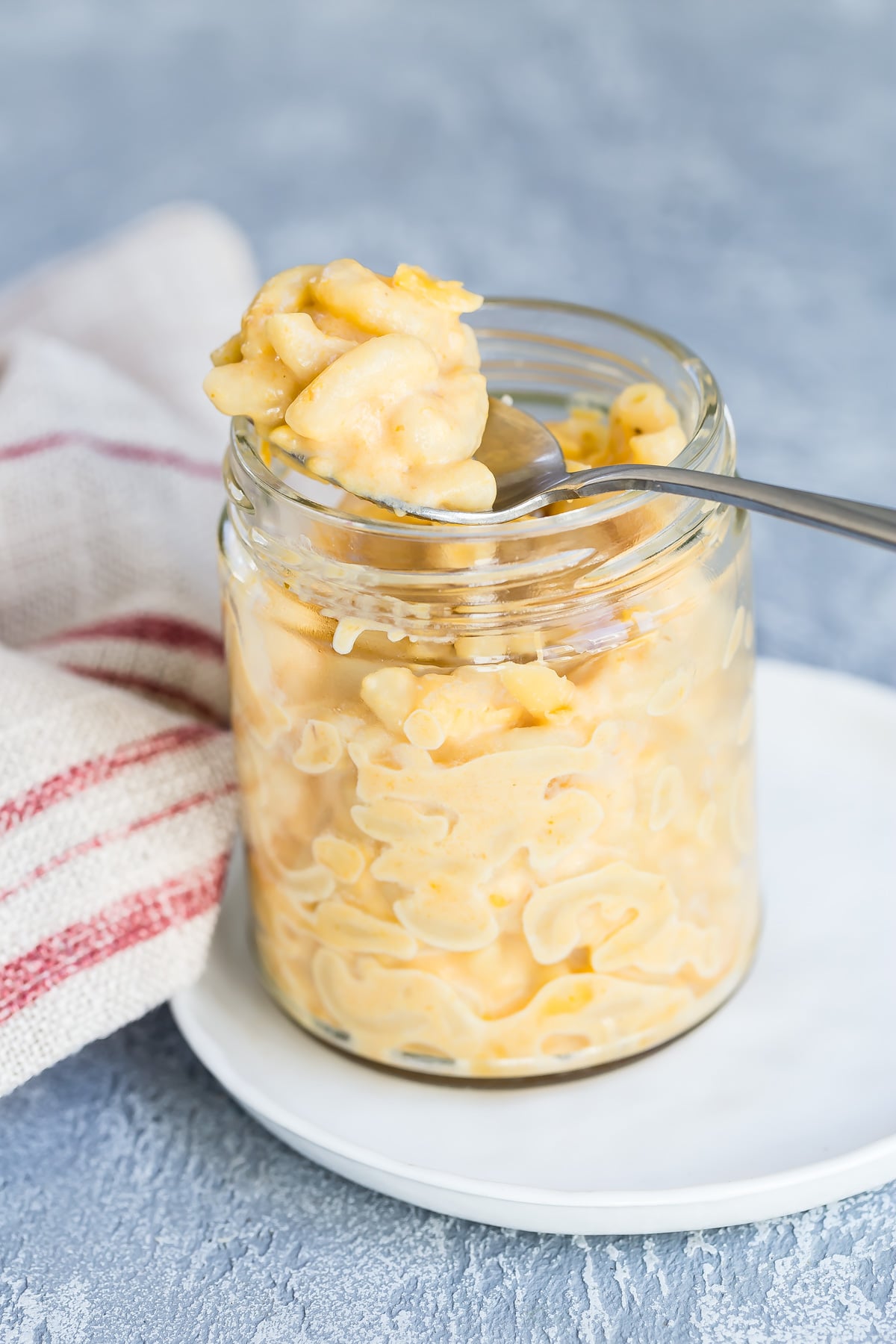 Pumpkin Mac and Cheese in a mug with spoon.
