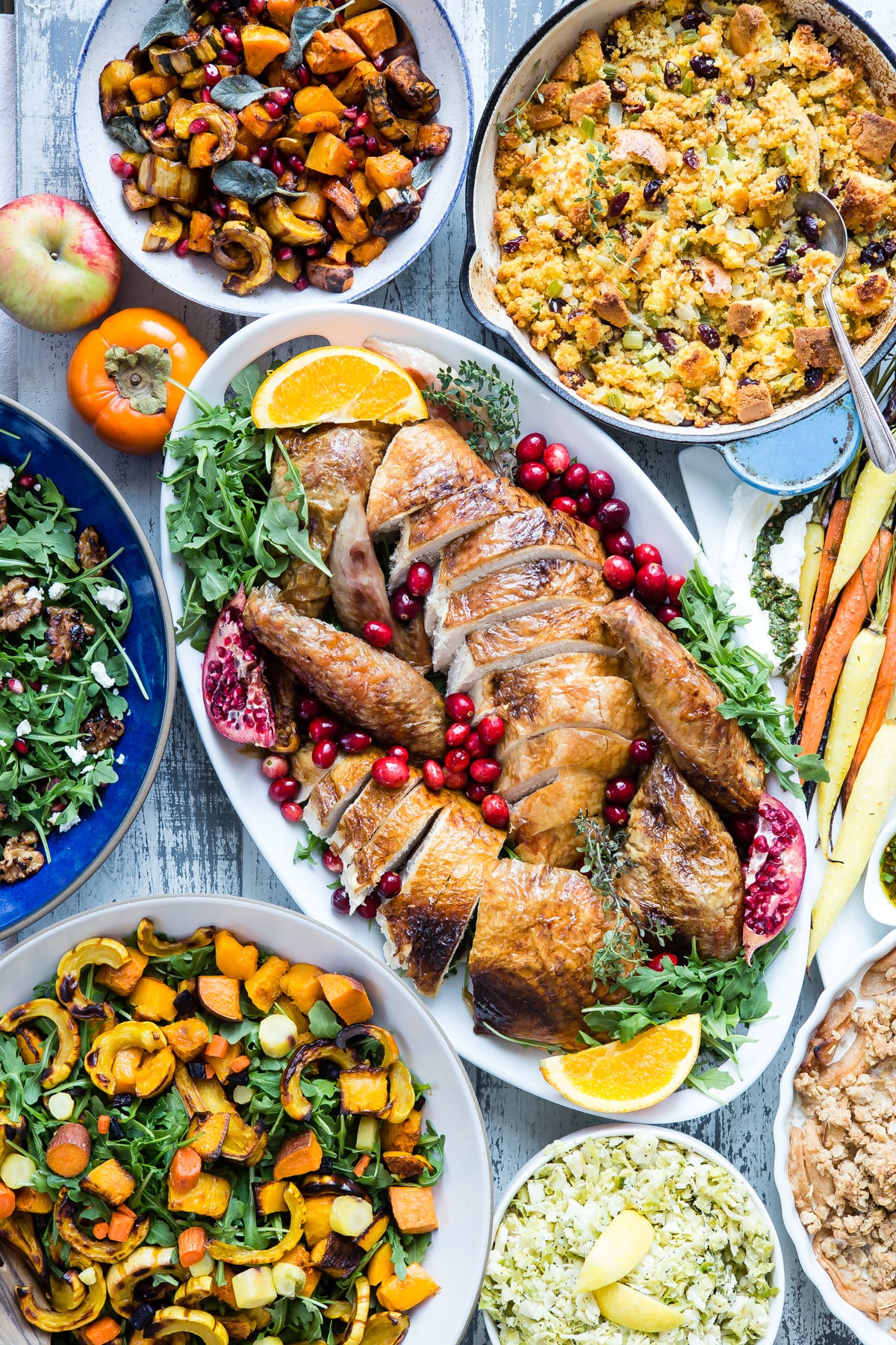Carved turkey with thanksgiving sides surrounding it.