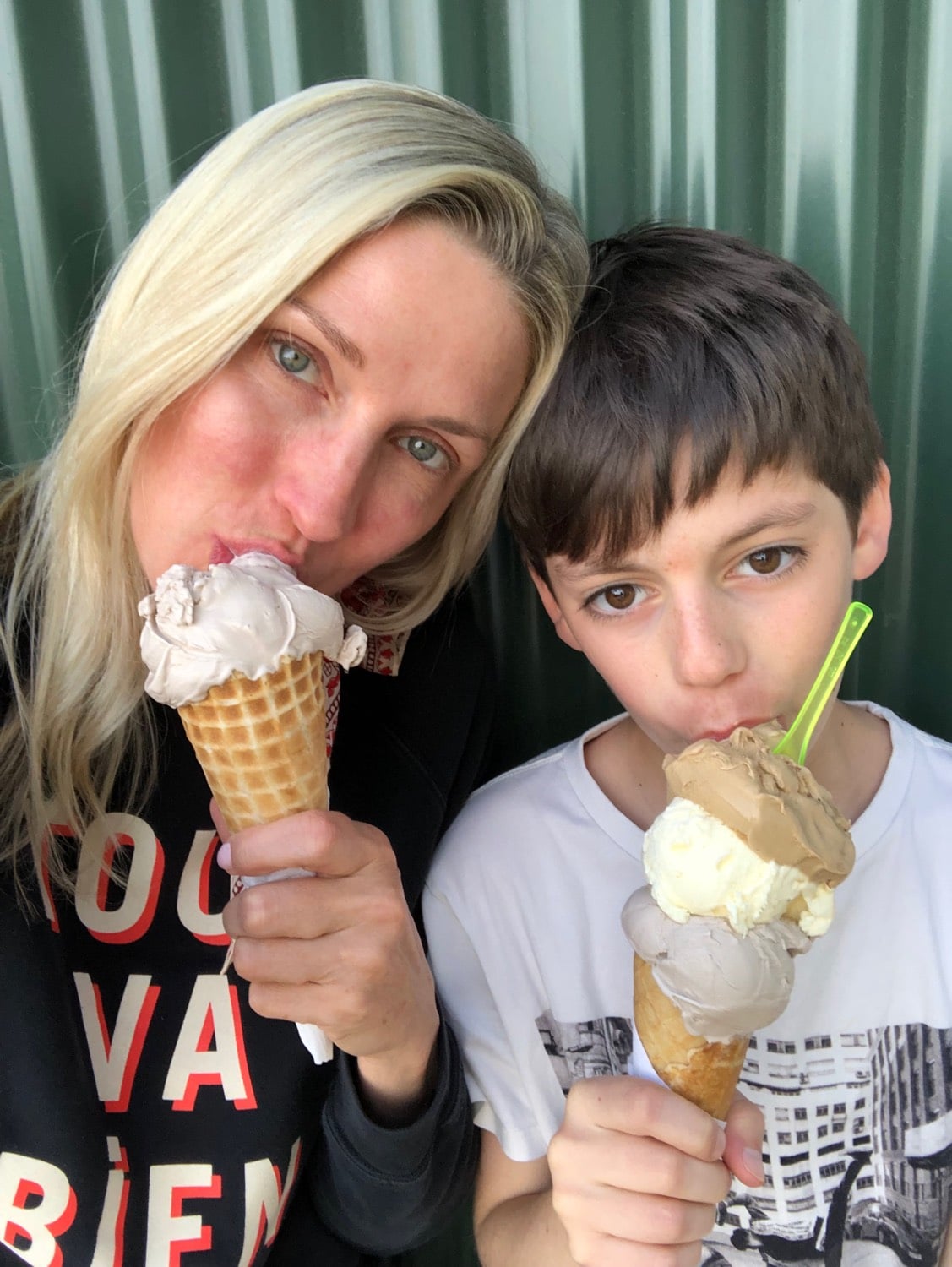 Mother and son eating ice cream cones.