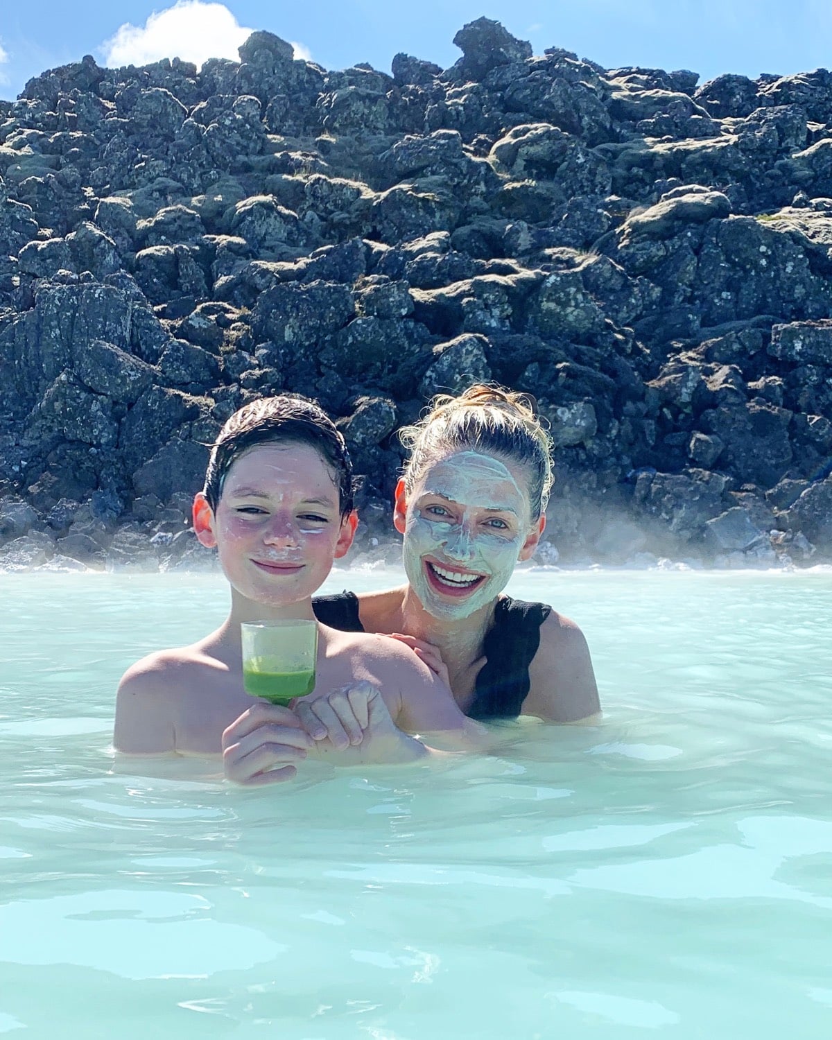 Mother and son relax in the Blue Lagoon in Iceland.
