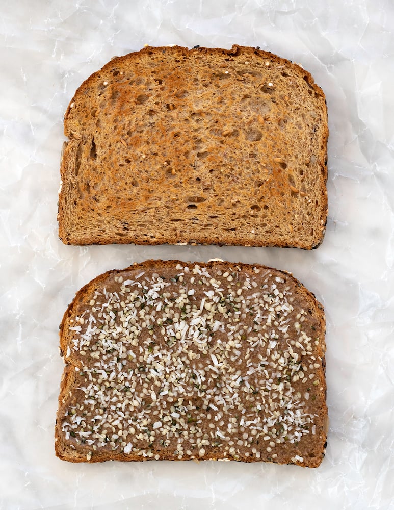 Chocolate sunbutter and seeds sandwich on white background.