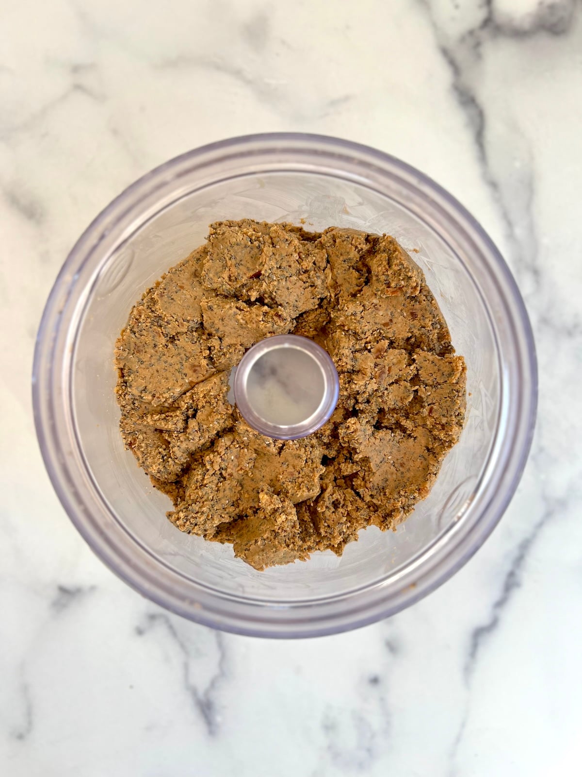 Protein ball ingredients combined in food processor.