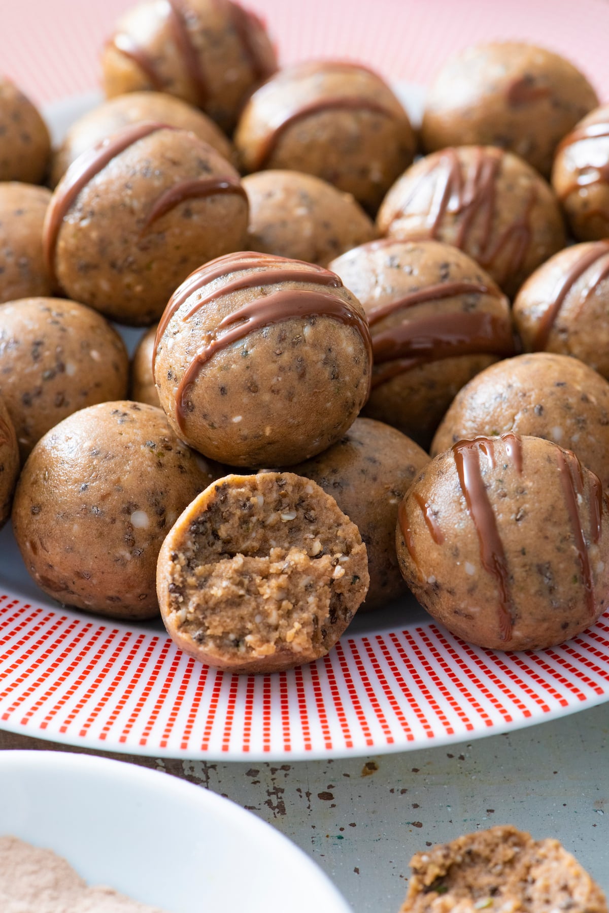Protein Balls drizzled with chocolate on a plate.