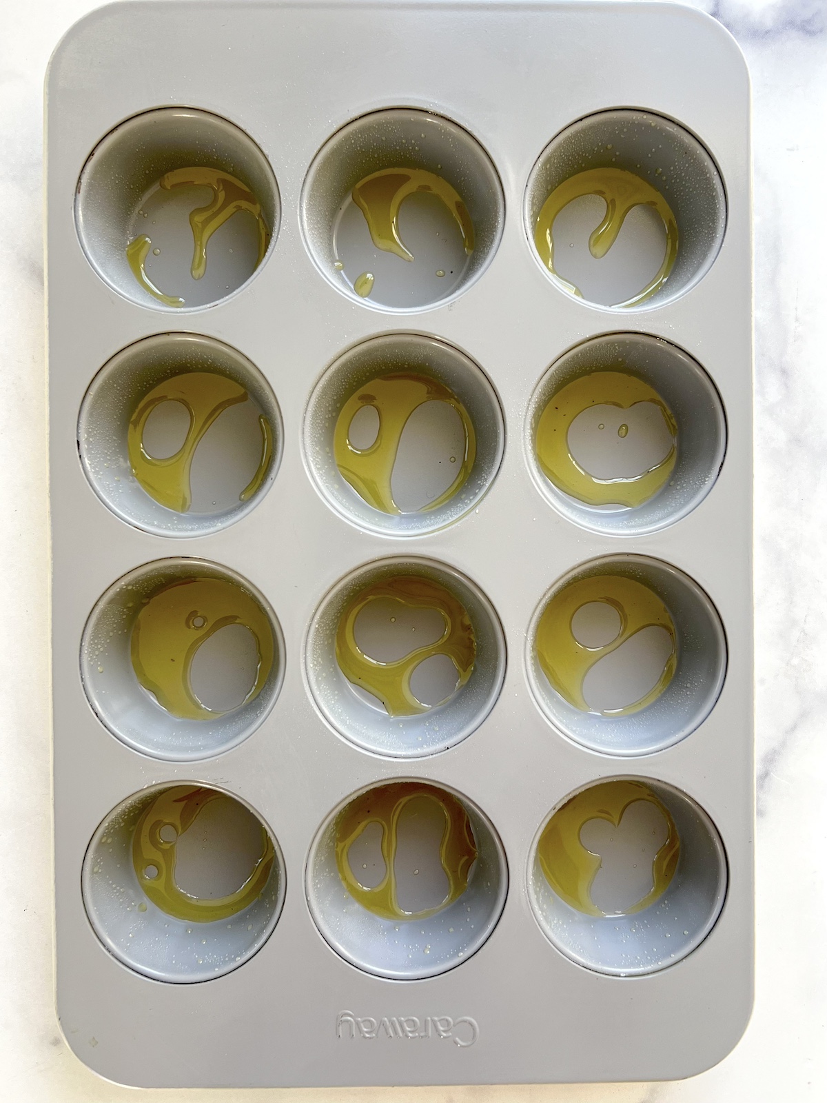 Greased muffin tin ready for batter.