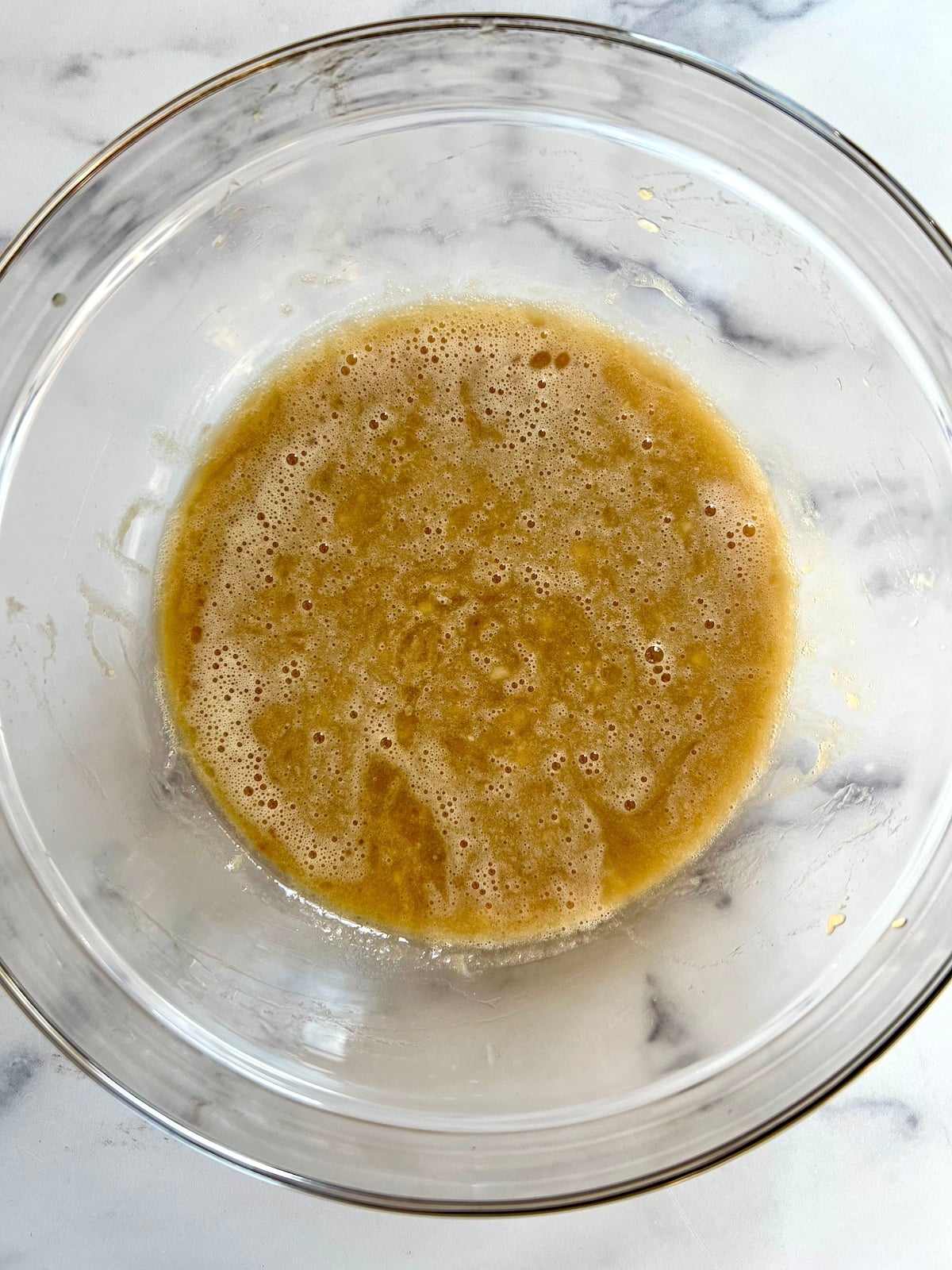 Banana wheat germ muffin wet ingredients combined in mixing bowl.