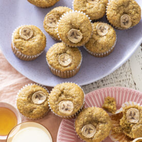 Banana Wheat Germ Muffins on pink and purple plates.