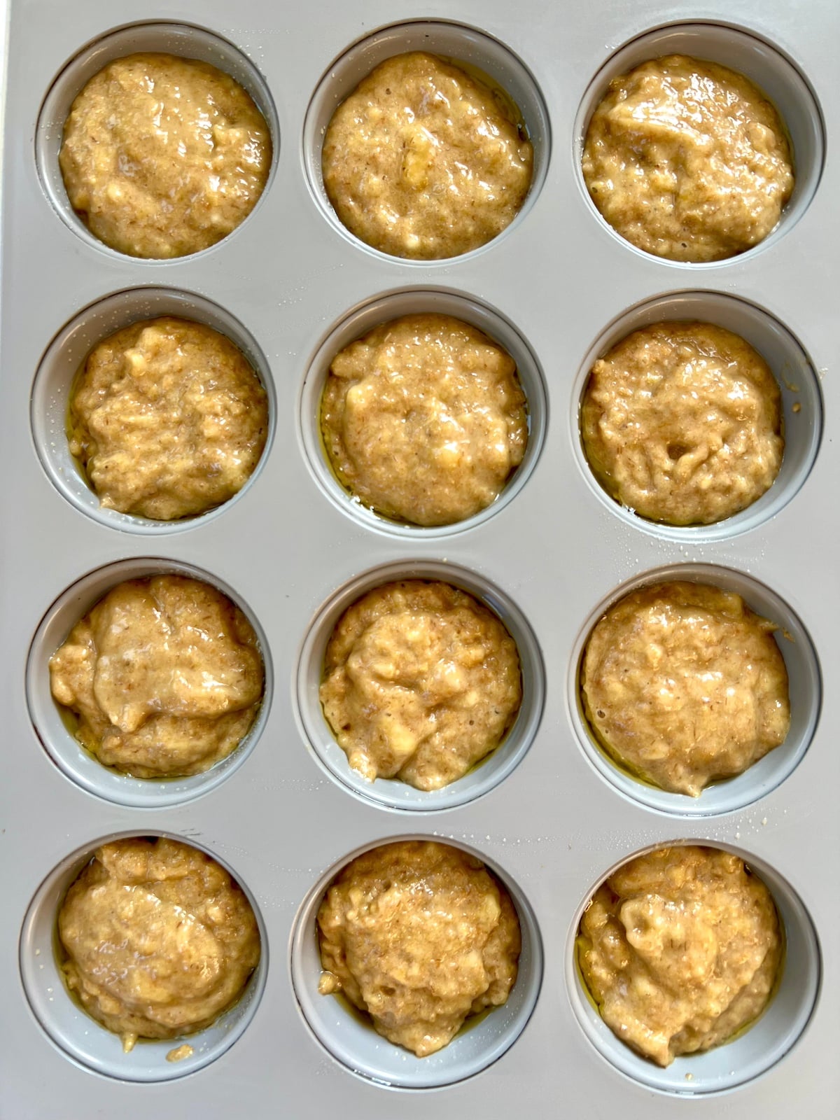 Wheat germ muffin batter in muffin tin.