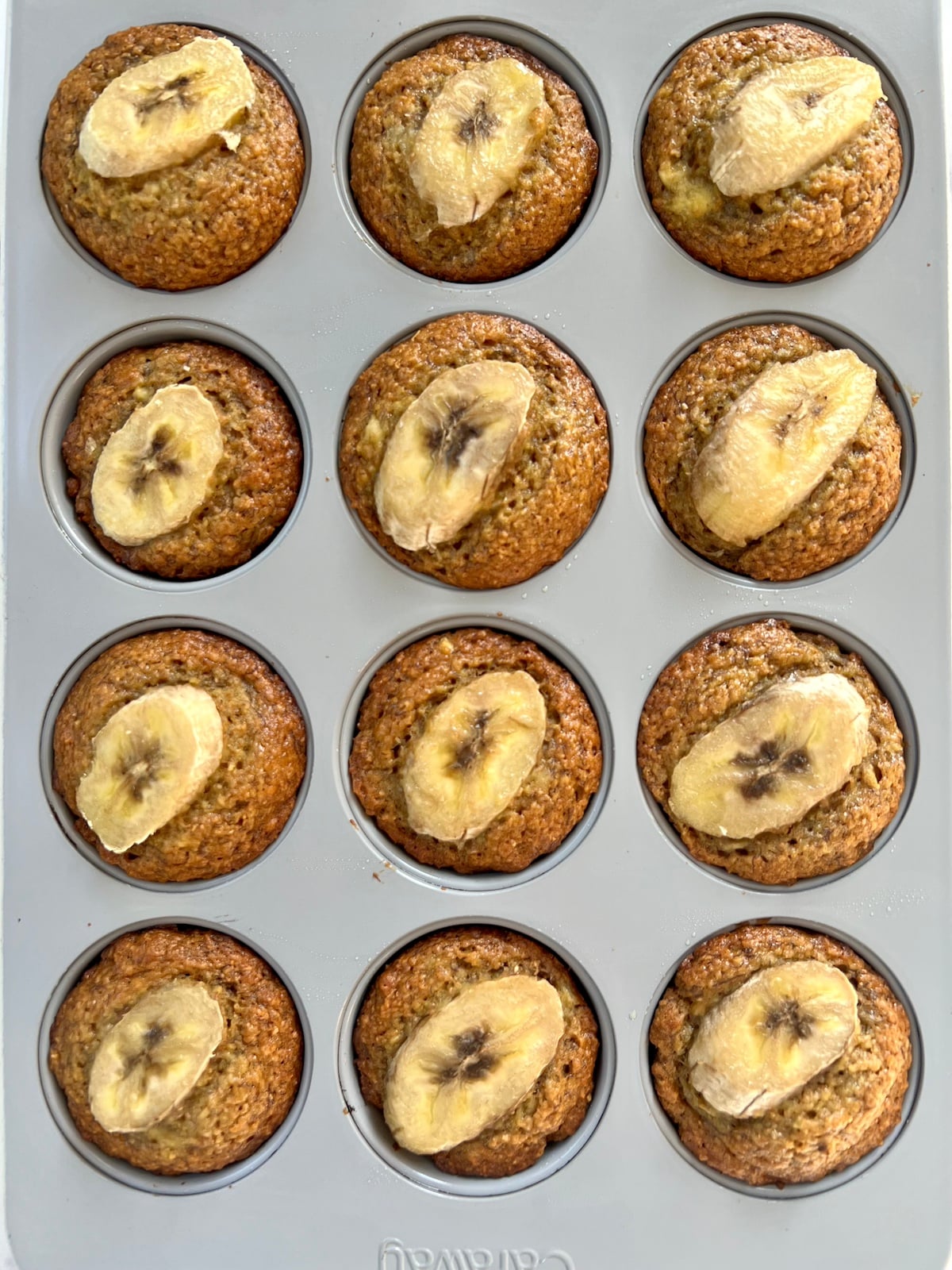 Baked banana wheat germ muffins in muffin tin.