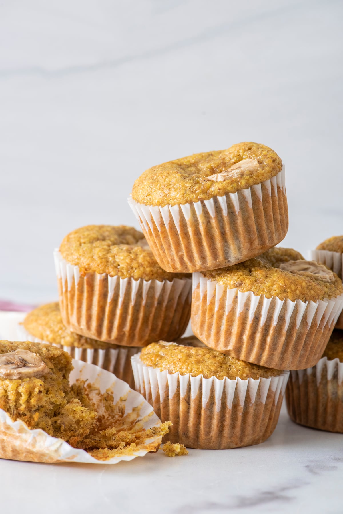 Banana wheat germ muffins stacked on top of each other.