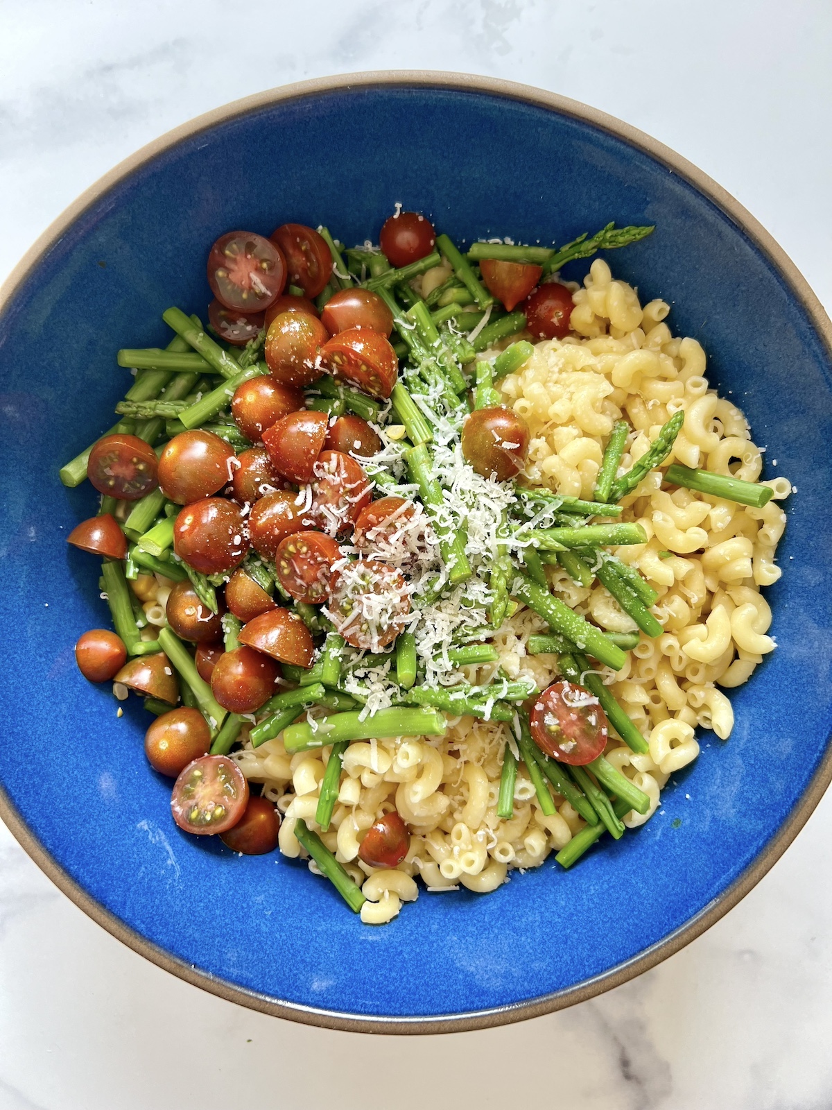 Summer pasta salad ingredients in a bowl.