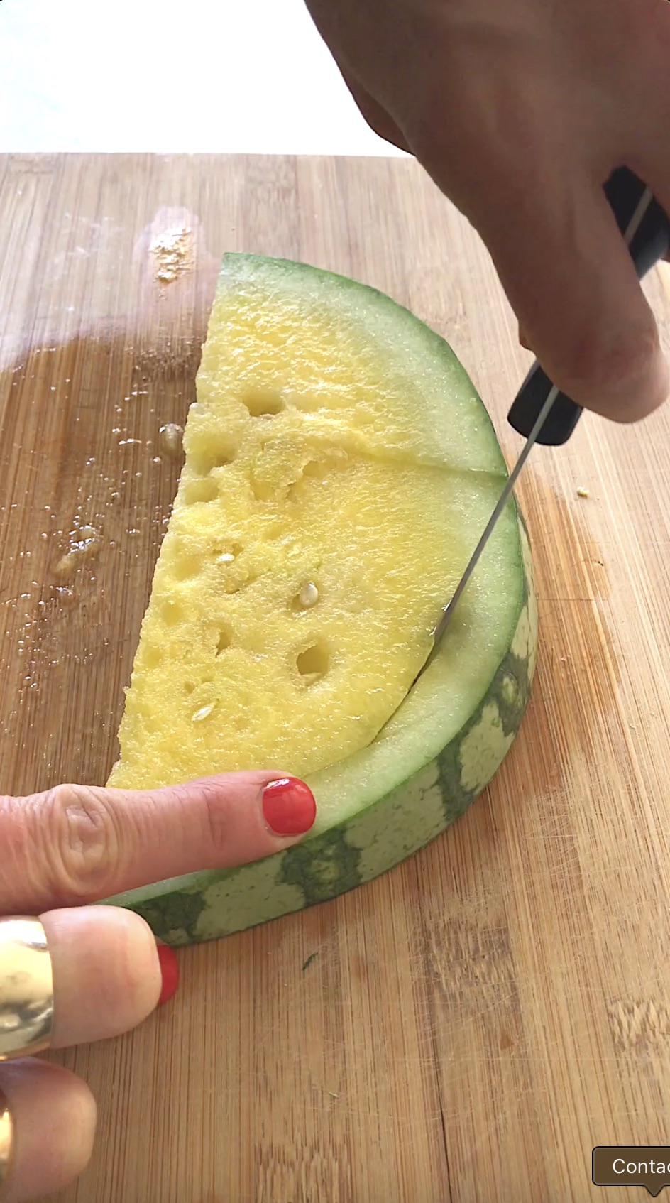 Cutting the watermelon rind from the watermelon flesh.