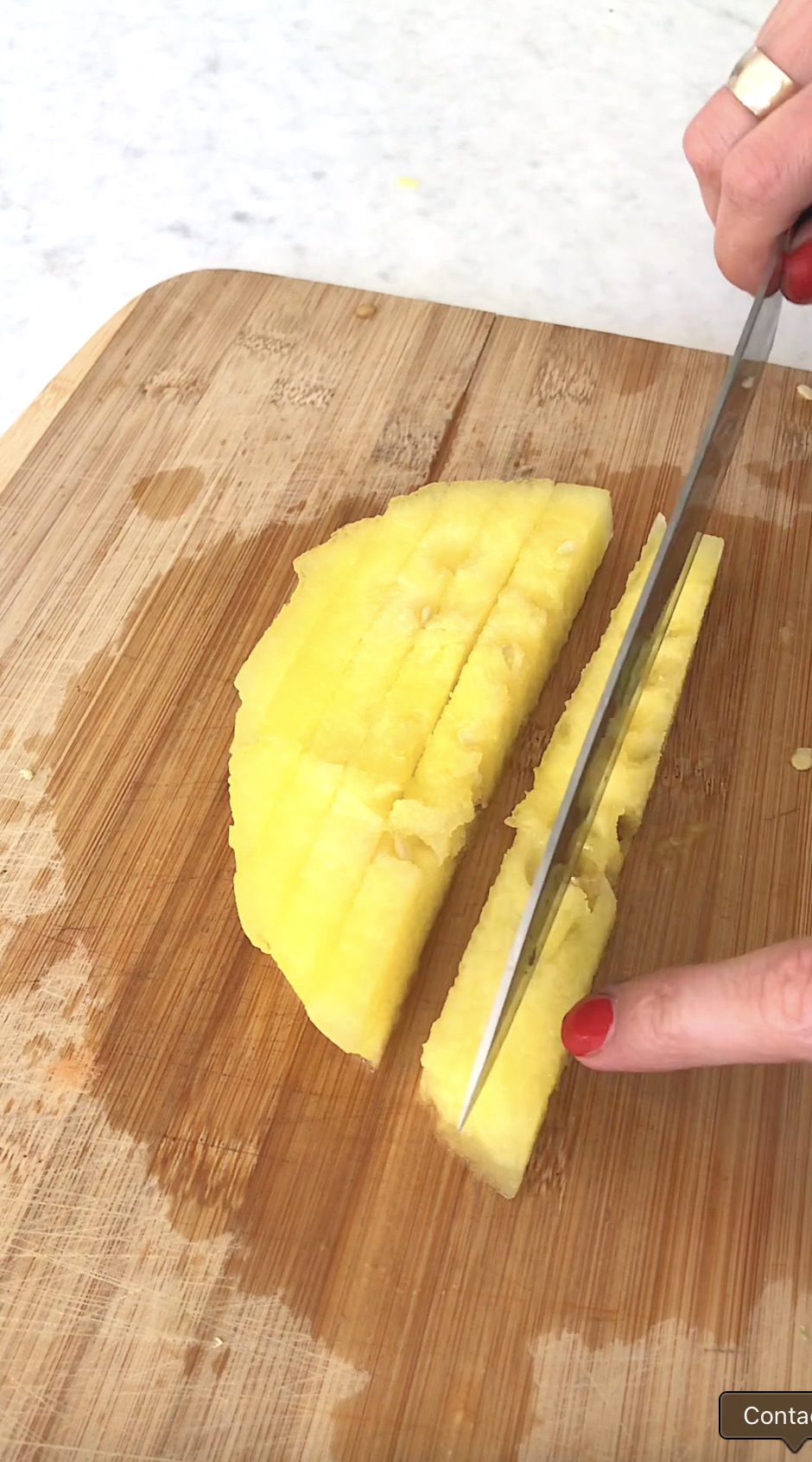 Slicing watermelon into small sticks.