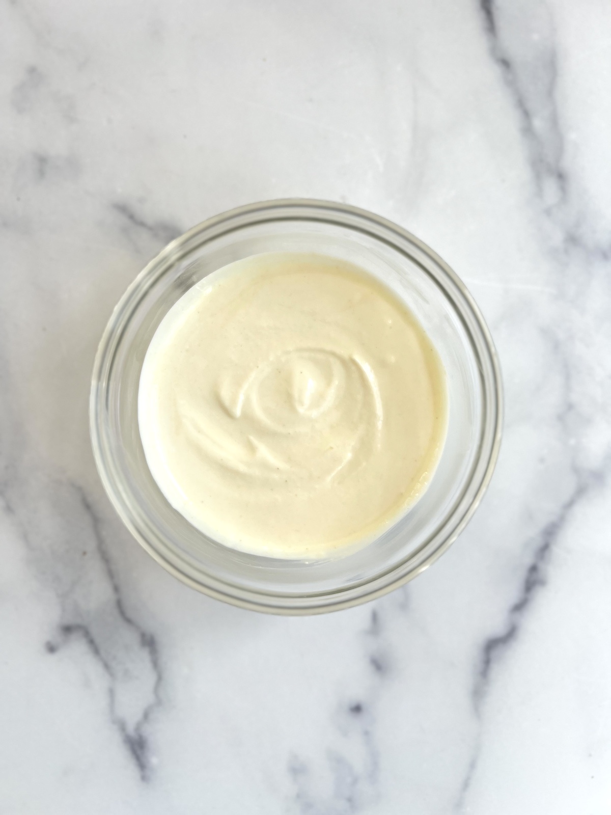 Honey lime yogurt dip in glass bowl.