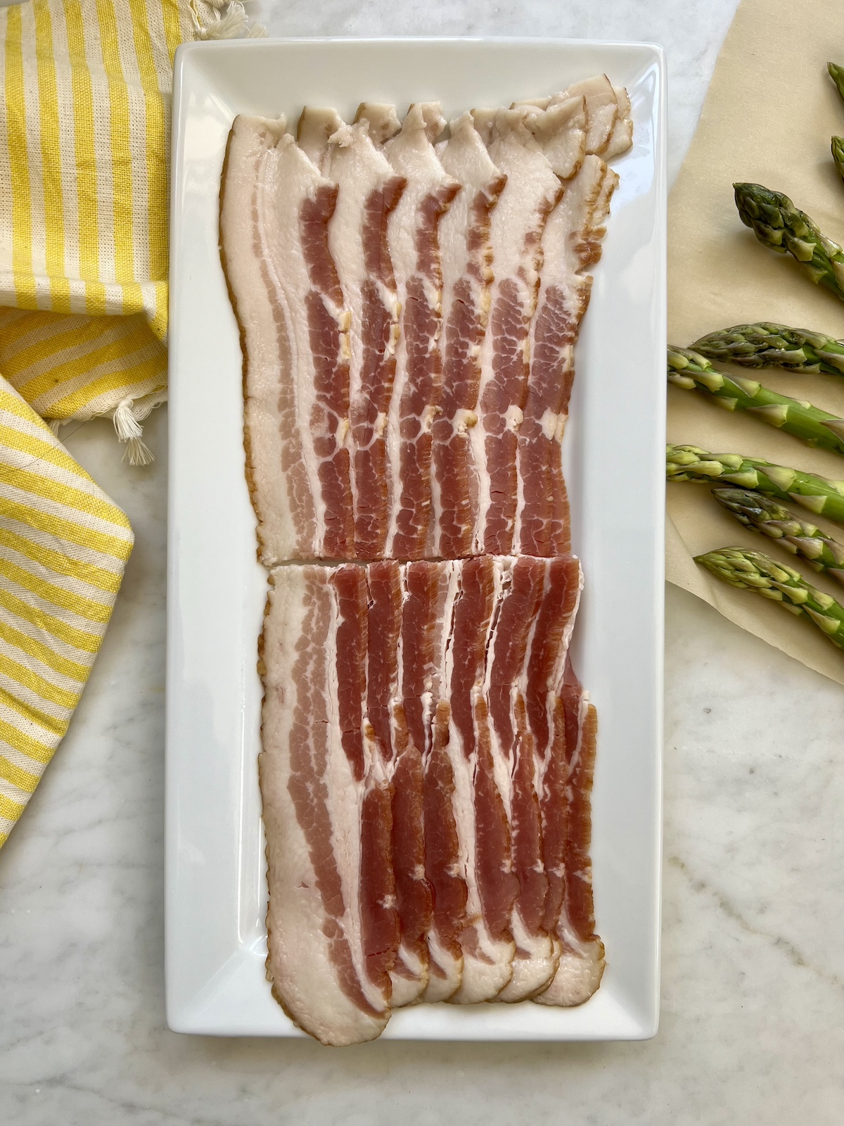 bacon slices cut in half on a plate.