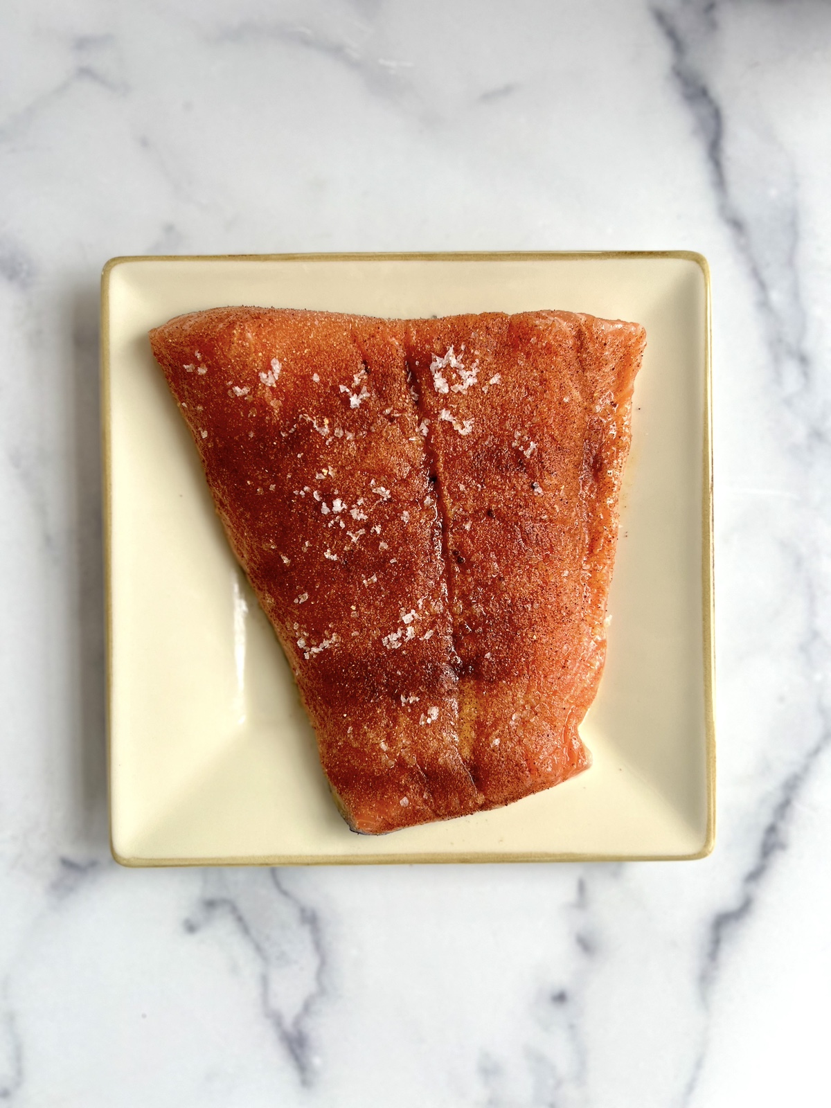 Salmon filet prepped with olive oil and seasonings.