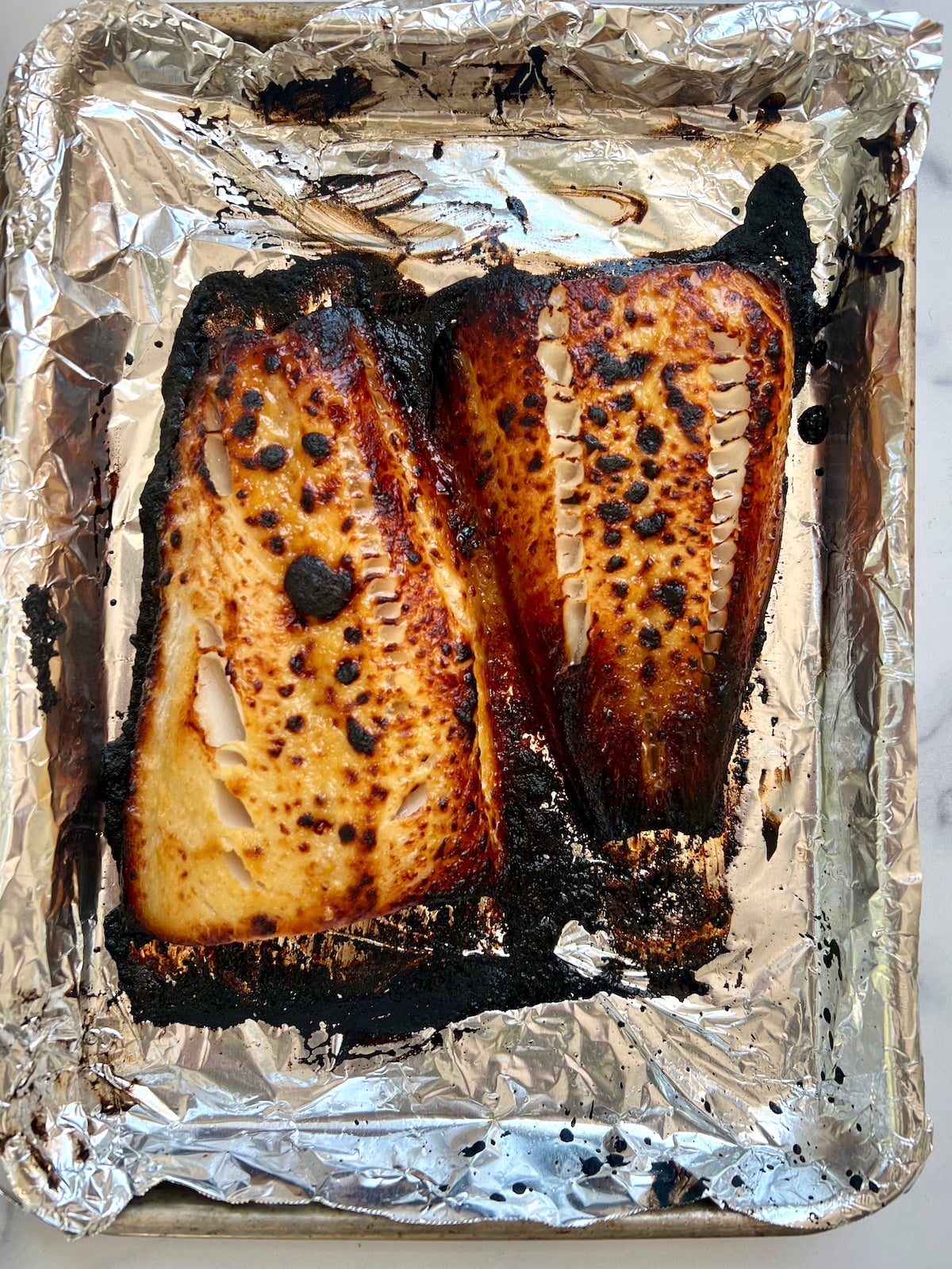 Cooked miso marinated black cod on sheet tray.