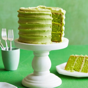 Green spinach layered cake on a cake stand.