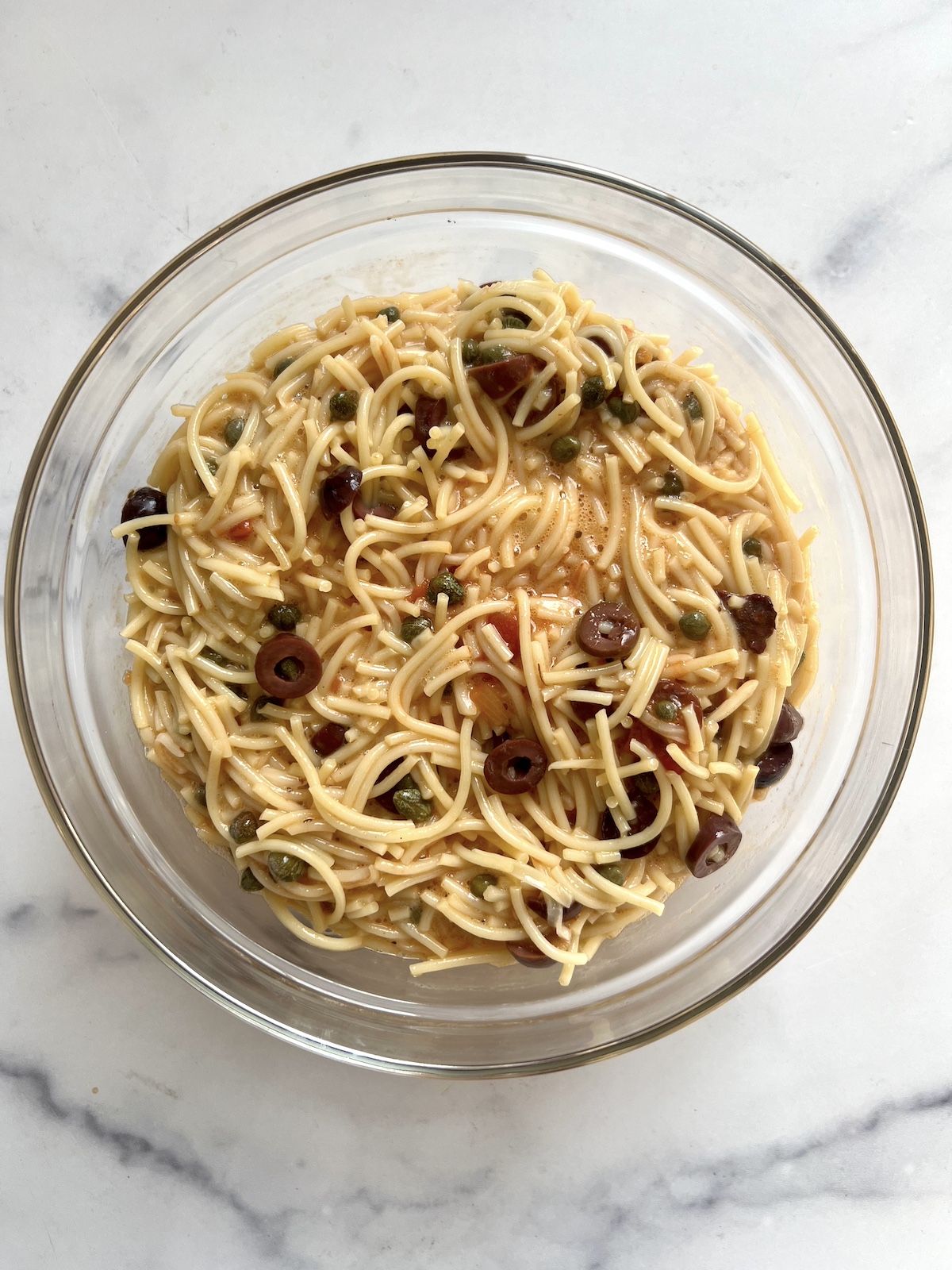 Spaghetti cakes mixture in a mixing bowl.