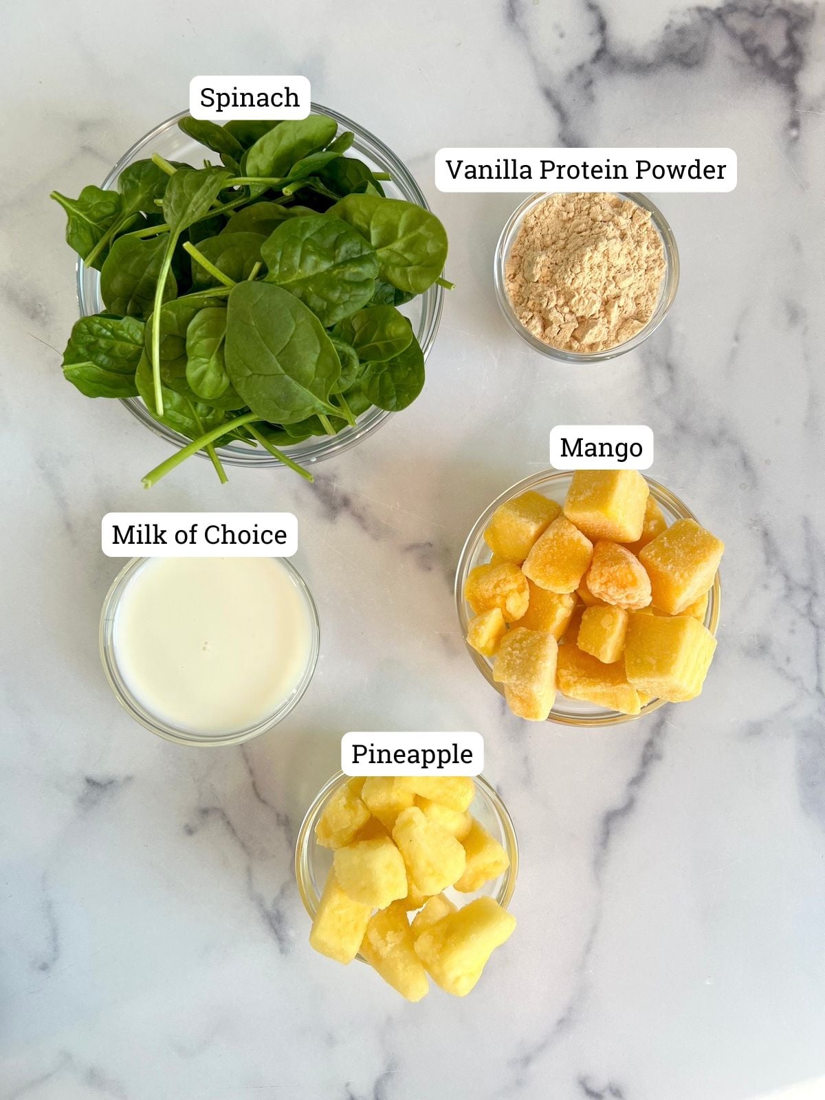 Ingredients needed for Tropical Protein Greens Smoothie.