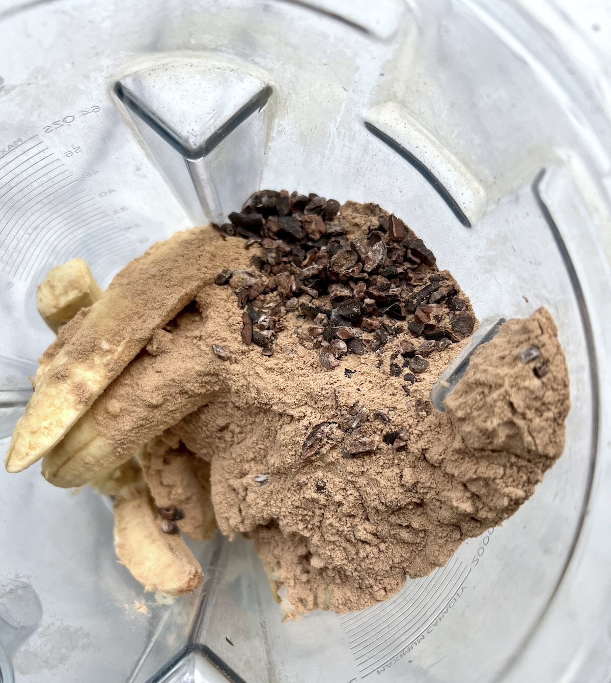 Chocolate smoothie bowl ingredients in a blender.
