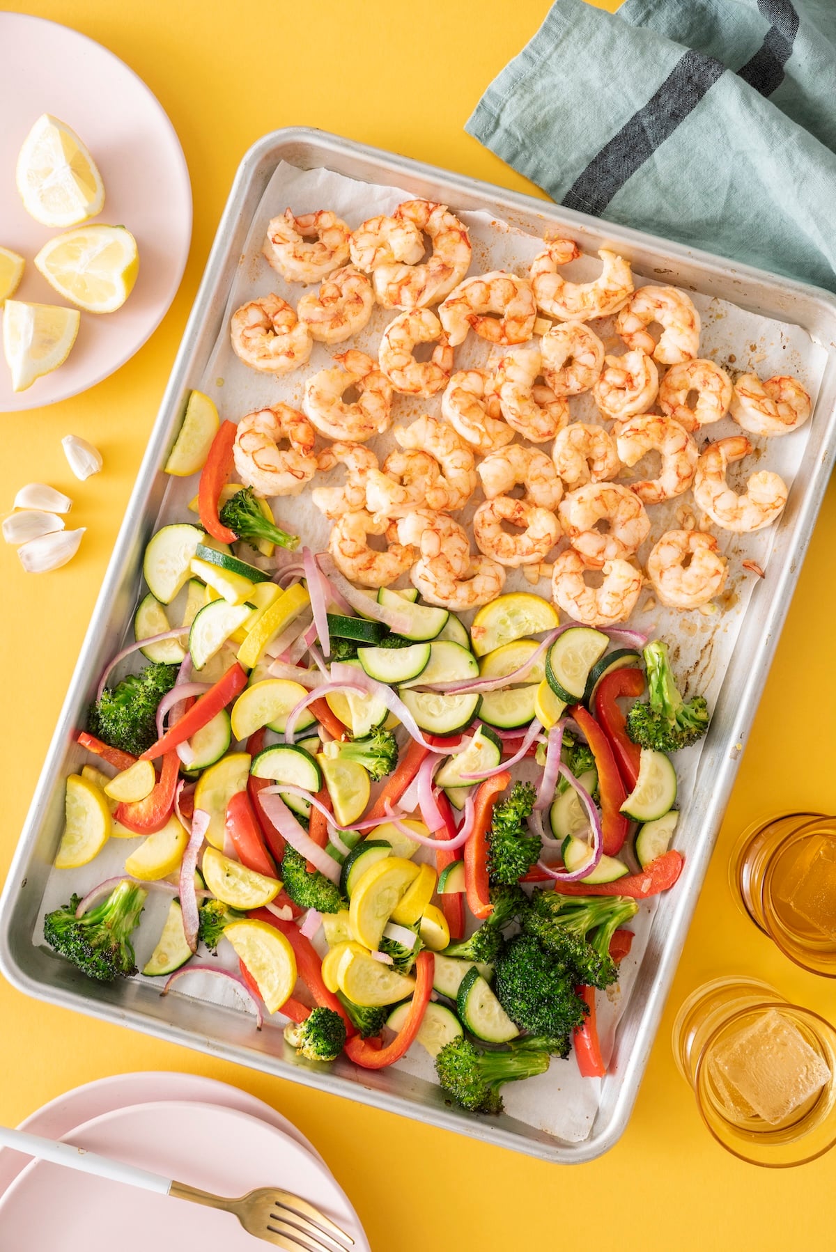 Sheet tray with roasted vegetables and shrimp.