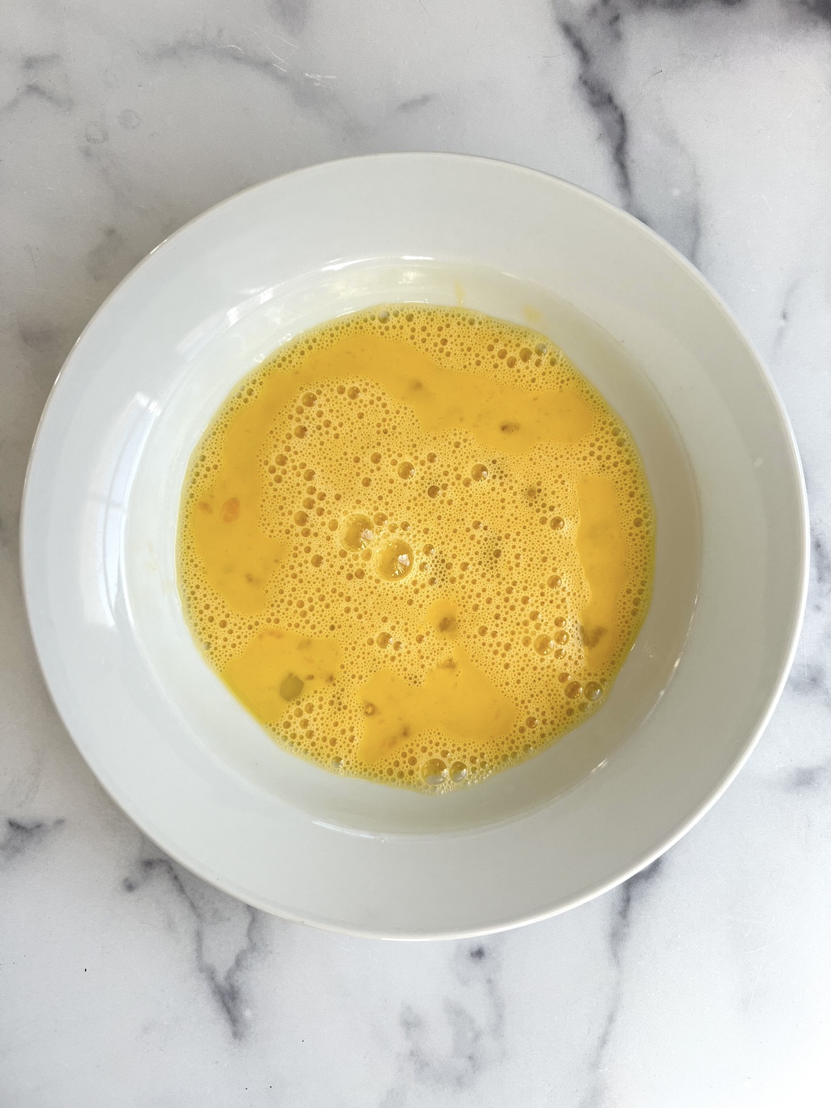 Whisked eggs in a bowl.